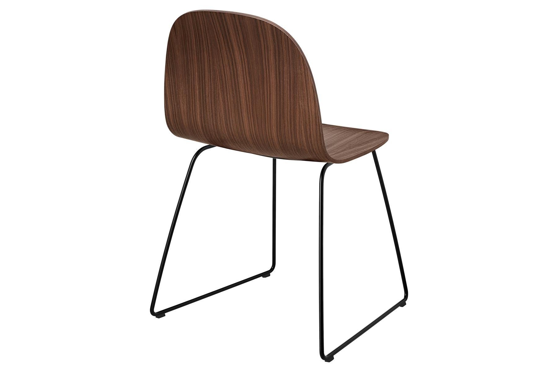 The Gubi 2D Chair is a series of light dining chairs made from laminated veneer with options for front upholstery in a wide range of fabrics and leathers, suitable for both private and public spaces. Being an extension to the Classic Gubi 3D chair,