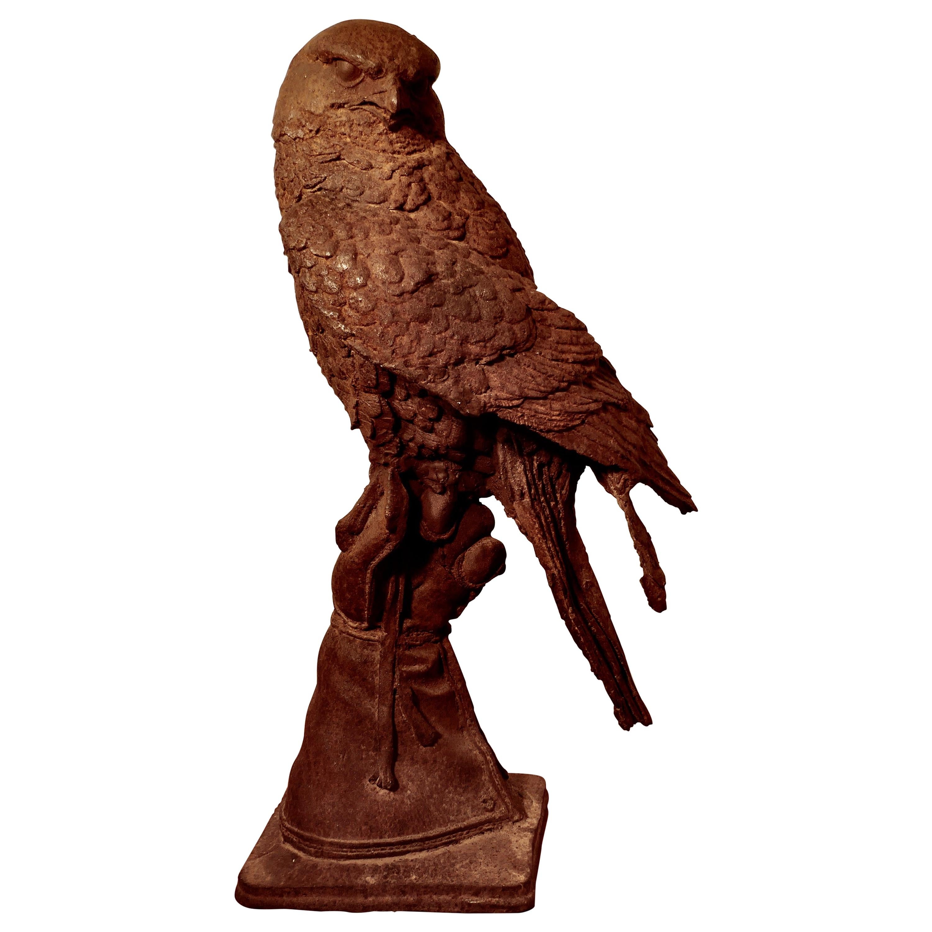 Weathered Cast Iron Statue of a Falcon on a Gloved Hand