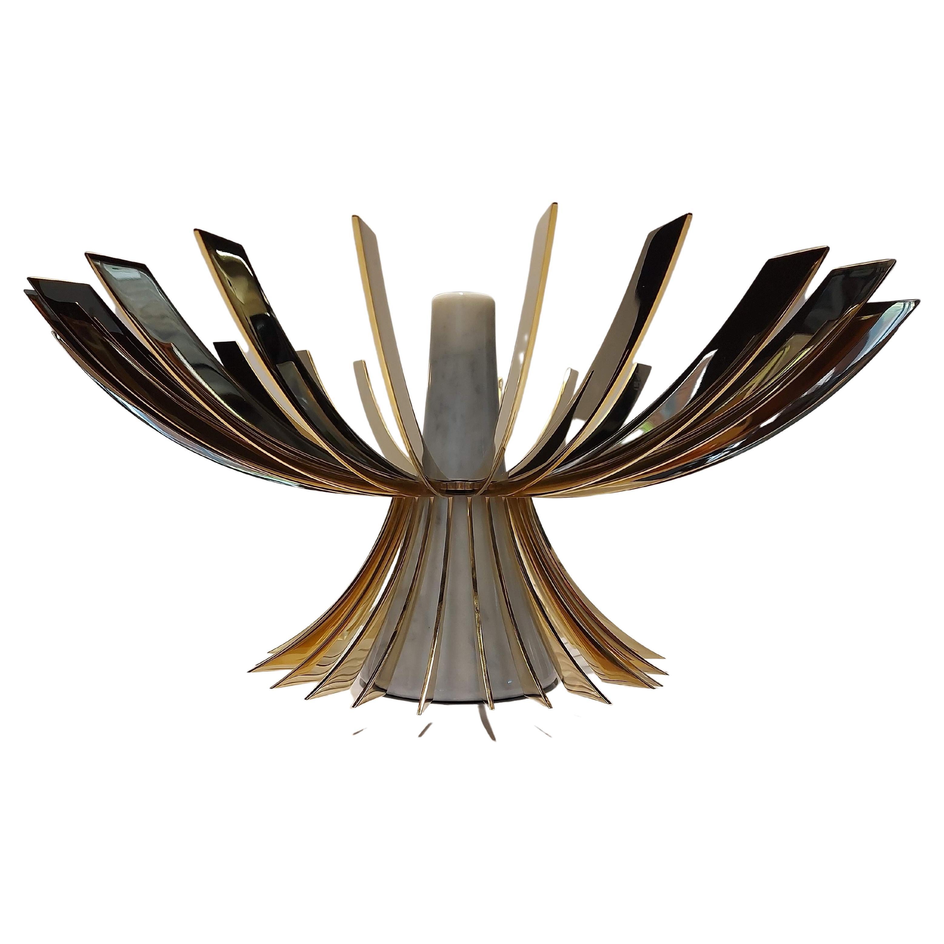 The Sagoma (or Silouhette) is a unique and one-of-a-kind Showpiece and Fruit Bowl made in Italy. 

A marriage between Marble and Metal. 24K Gold Fins are flowering out from its Marble core and create a Sagoma (a Silouhette or a Shape) of a bowl.