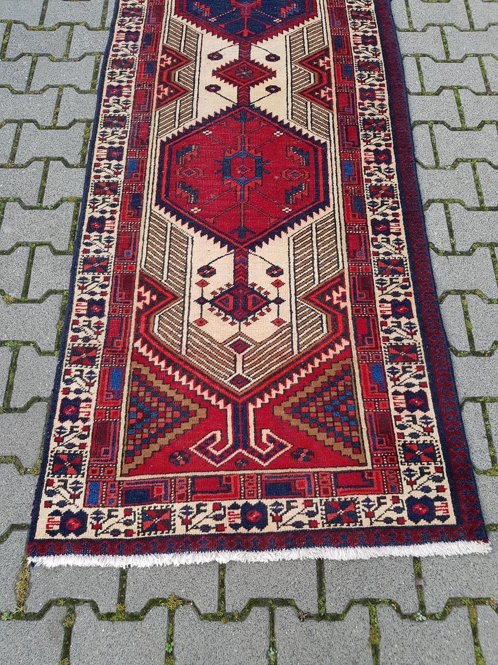 Kurdistan hand knotted carpet made of wool with cotton warp, it has a beautiful color pattern of red, beige and blue. This one is made in the second half of the 20th century and has wear consistent by age and use.

The measurements are,
With 95