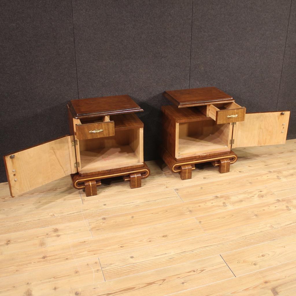 Pair of Italian bedside tables from the mid-20th century. Art Deco style walnut, mahogany, maple and fruitwood veneer furniture. Bedside tables equipped with a drawer, a door with a large internal compartment, an upper support shelf and a magazine