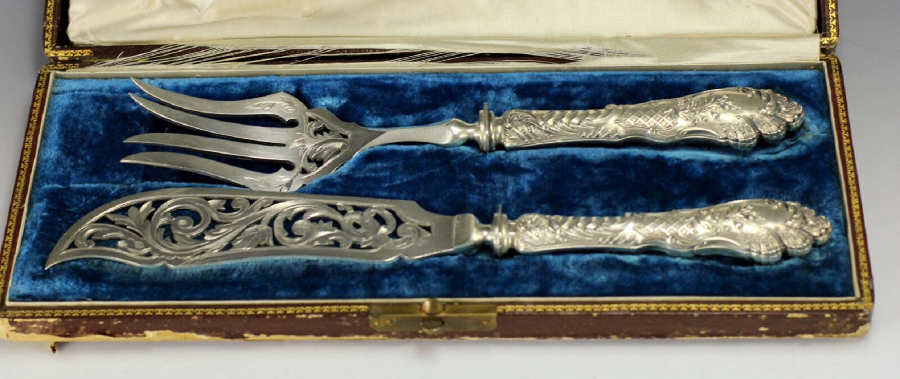 2pc Set French Sterling Silver Fish Servers Henri Dubret - Original Case, c1905 

Elegant Repousse Handles embellished with foliate scrolls, and twist fluted details. Reticulated blades feature hand engraved designs that complement the designs on