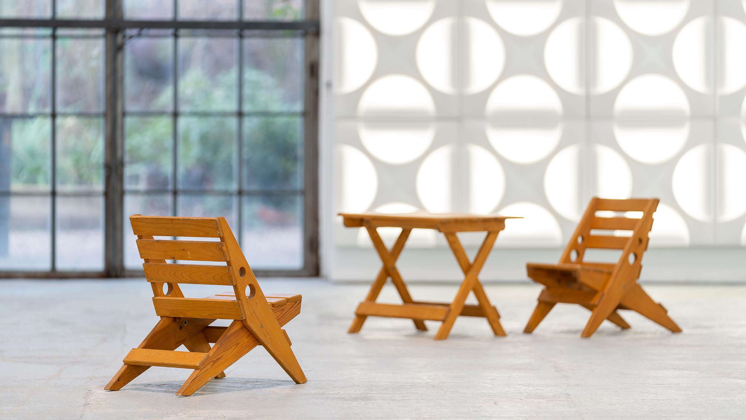 extremely charming set consisting of 2 folding chairs and a folding table, made of pine wood with fine brass details.

the chairs are based in design on the scissor chairs by charlotte perriand - they measure:
51cm high - 34.5cm wide and 56cm deep.