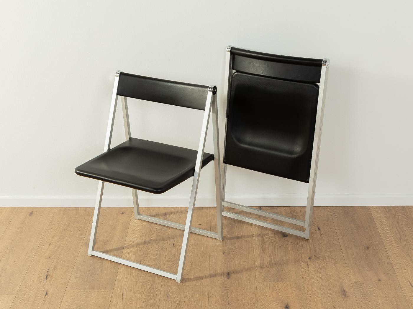 Timeless folding chairs by Swiss designer duo team form ag (Franz Hero & Karl Odermatt) for interlübke from the 1970s. High-quality stainless steel frame with backrest and seat made of plastic in black. The offer includes 2 chairs.

Quality
