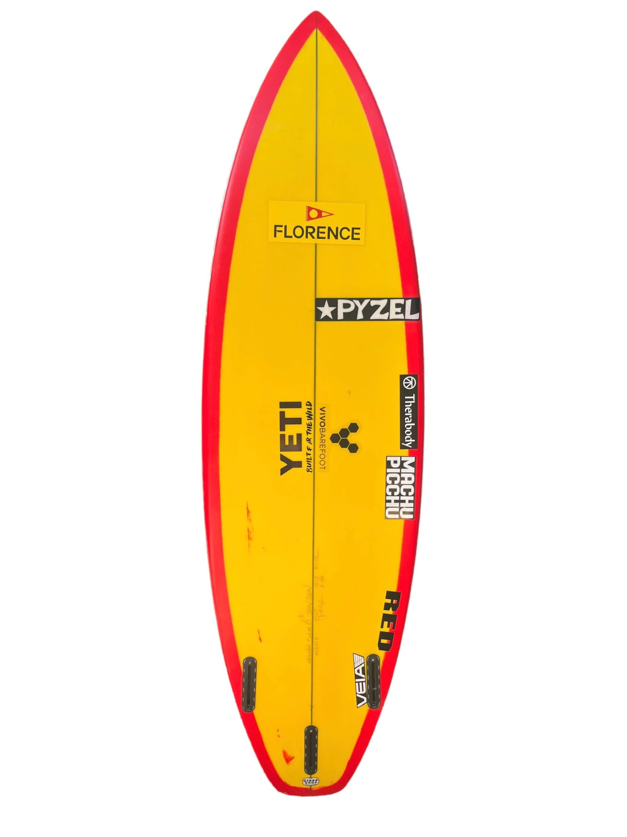 2X World Champion John John Florence’s personal surfboard shaped by Jon Pyzel. Featuring bright red tint/wrapped rails and yellow bottom, squash tail. John John Florence was the 2016 and 2017 WSL World Champion. Florence is one of only four world