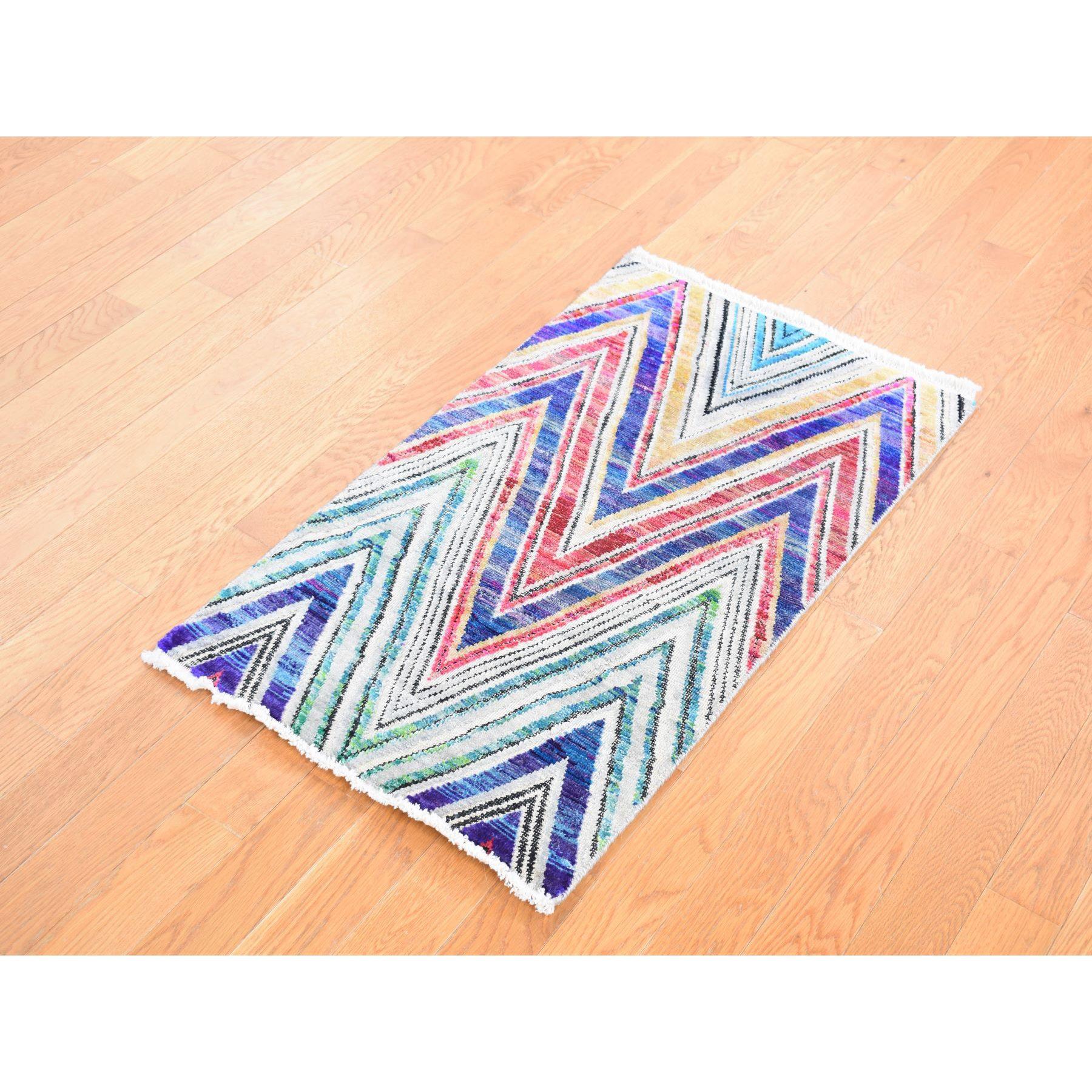 Raspberry Red, Hand Knotted, Chevron Design, Sari Silk with Textured Wool, Oriental Rug
Primary materials: Wool 
Silk
Latex: No Pile 
height: 0.25 Inches
Style: Transitional
Primary color: Red
Secondary colors: Blue, Ivory, Black, Yellow,