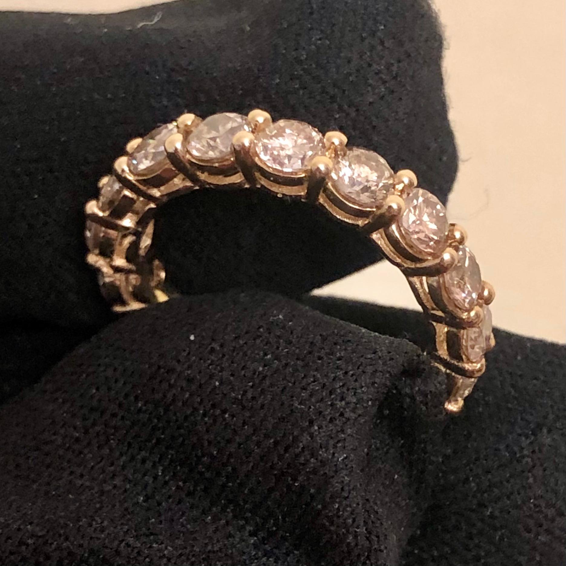 Stunning 3 1/2 carat round diamond full eternity band ring in 14k yellow gold. 17 round SI-I clarity solitaire diamonds are hand set in this full eternity band weighing approx. 3.53 carats. 


17 natural 1/5 carat solitaire earth-mined diamonds are