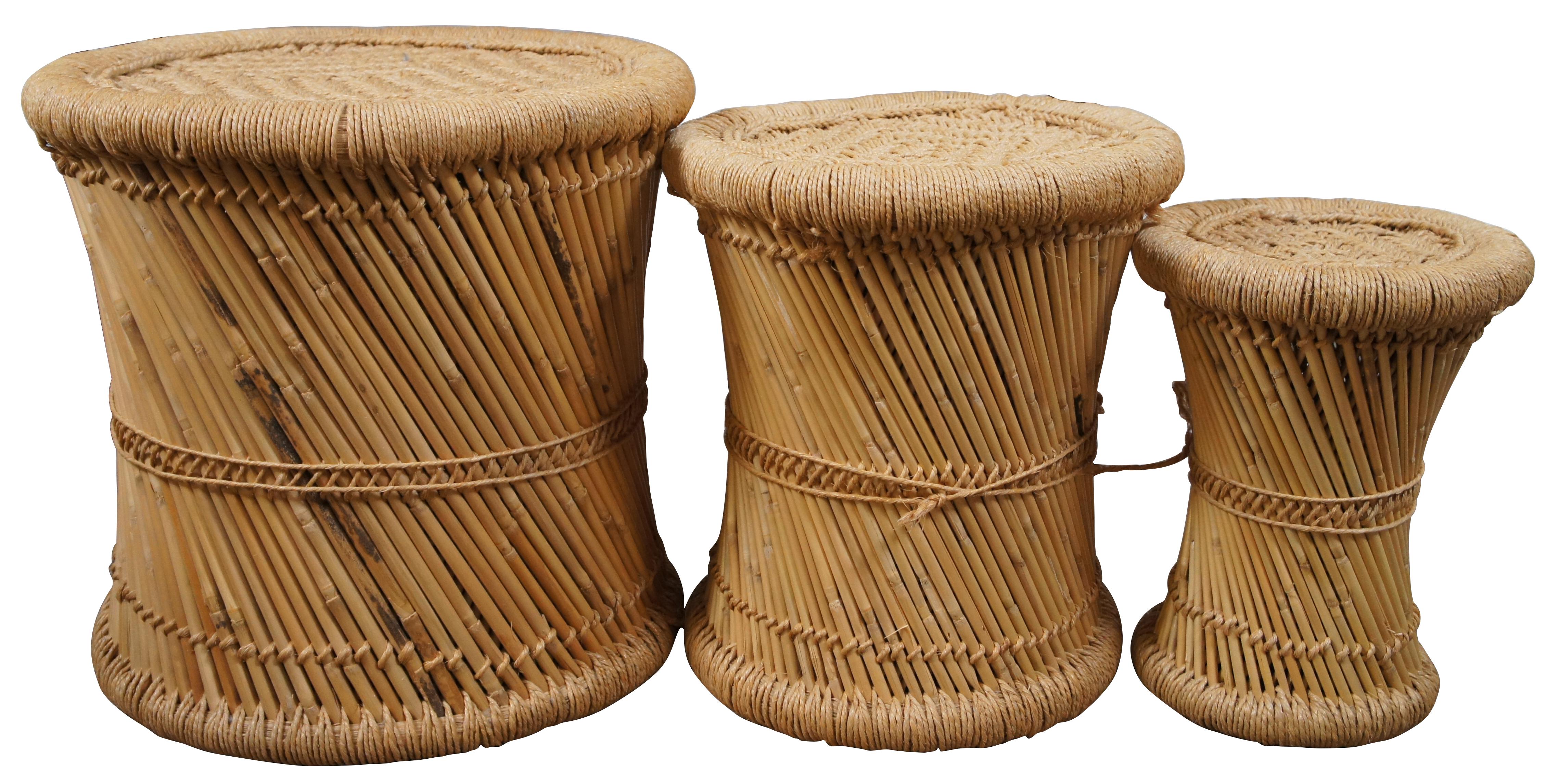 Set of three vintage circa 1970’s round end tables or stools made of cane / bamboo with a pinched waist, spirals design, finished with wrapped sisal / jute cord edges and diamond woven tops. Hollow base, can nest together.

Large - 17” x 16.5” /