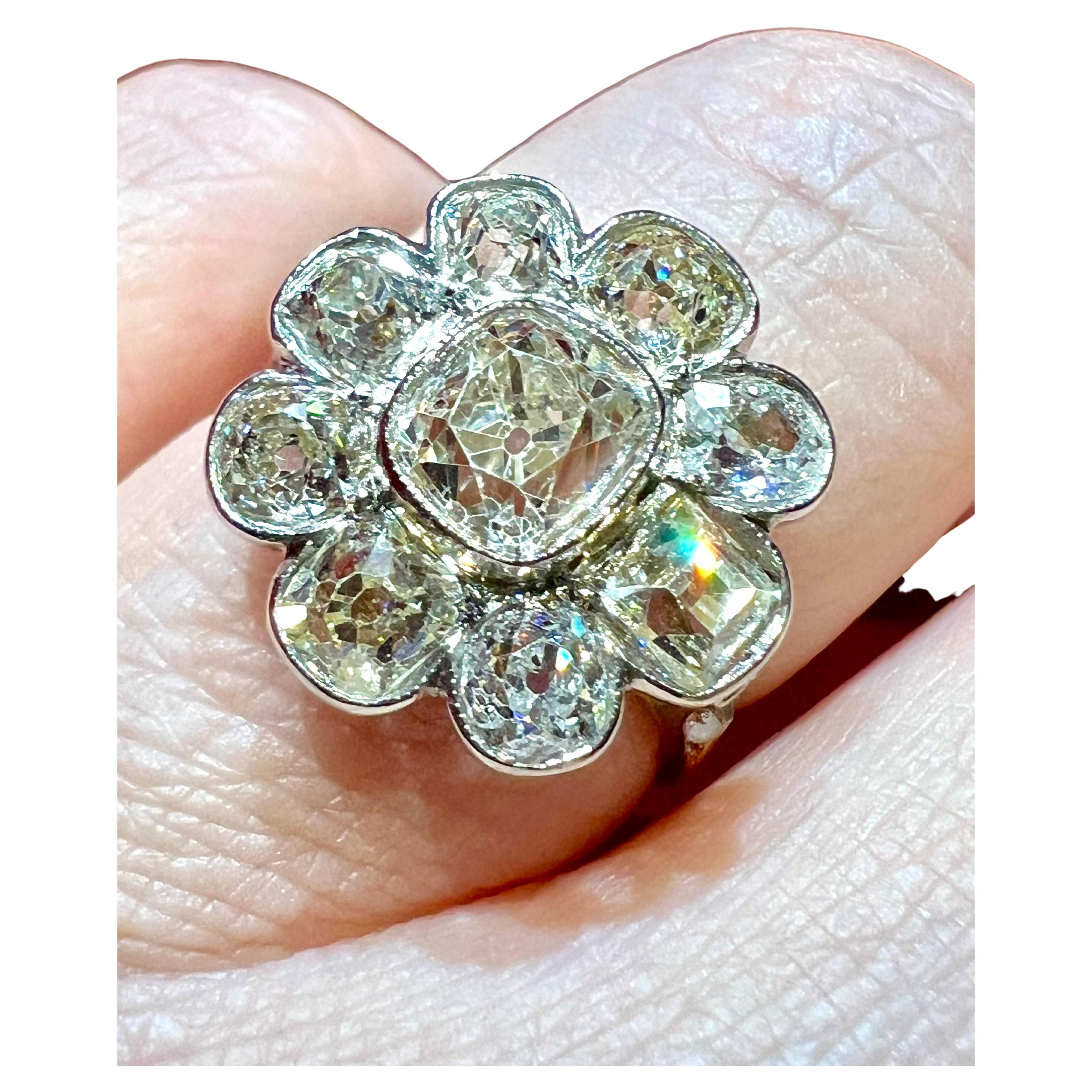 Flower-shaped ring set with old-cut diamonds with a cushion-cut diamond of approx. 1.20 ct in the center and a surround of 8 diamonds
for a total of approx. 3.20 ct 
Period: Second half of the 19th century
total weight: 4.13gr
size: 52.5cm 
flower