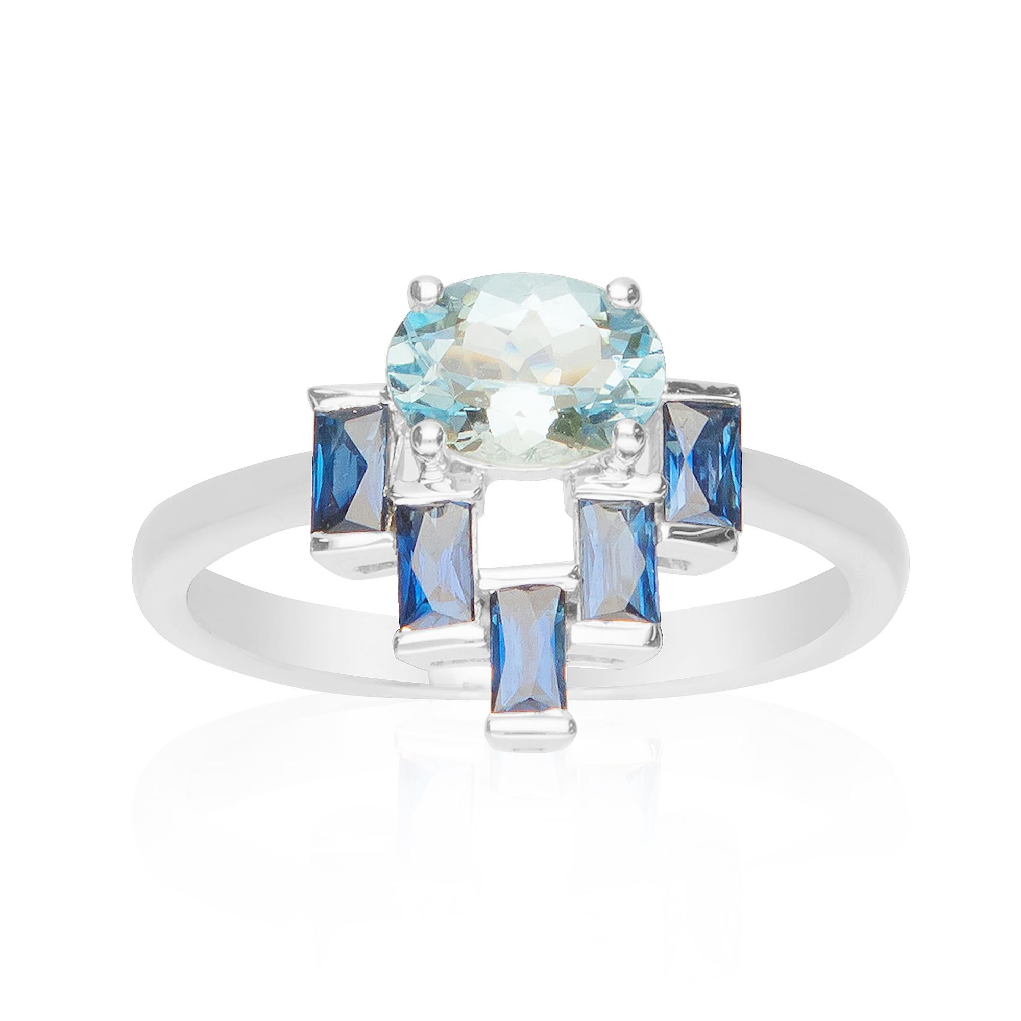 This unique designer ring is crafted in 18-karat White gold and features an oval cut 3/4 Carat Aquamarine and 5 Blue Sapphires 1/3 Ct. in a prong-setting. This ring comes in size 7 and is a perfect gift either for yourself or someone you love.