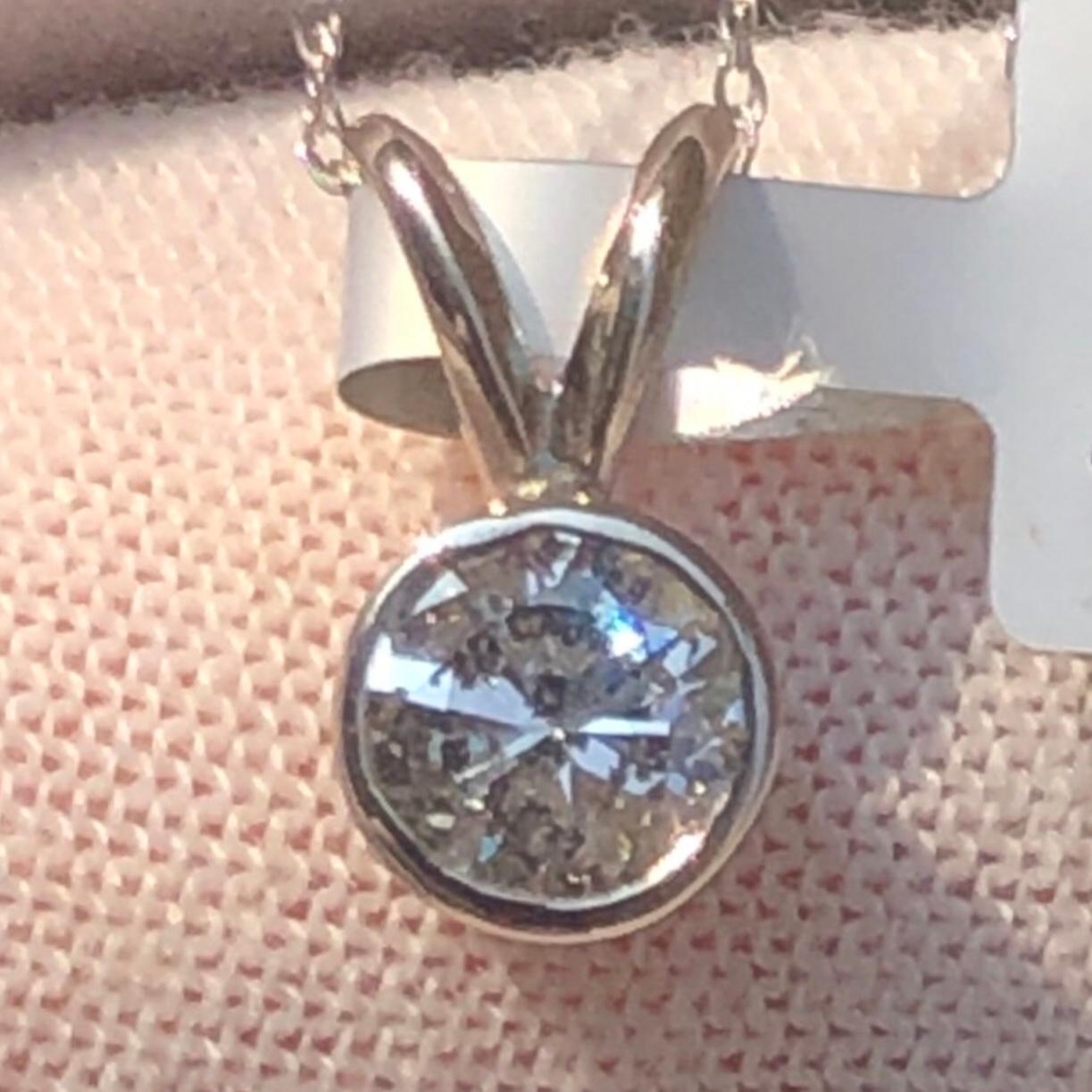 Classic 3/4 carat solitaire round diamond pendant necklace in 14k white gold. A large center 3/4 carat brilliant round diamond (size of an engagement ring) is natural earth mined, and bezel set in a pendant necklace. 3/4 carat solitaire round