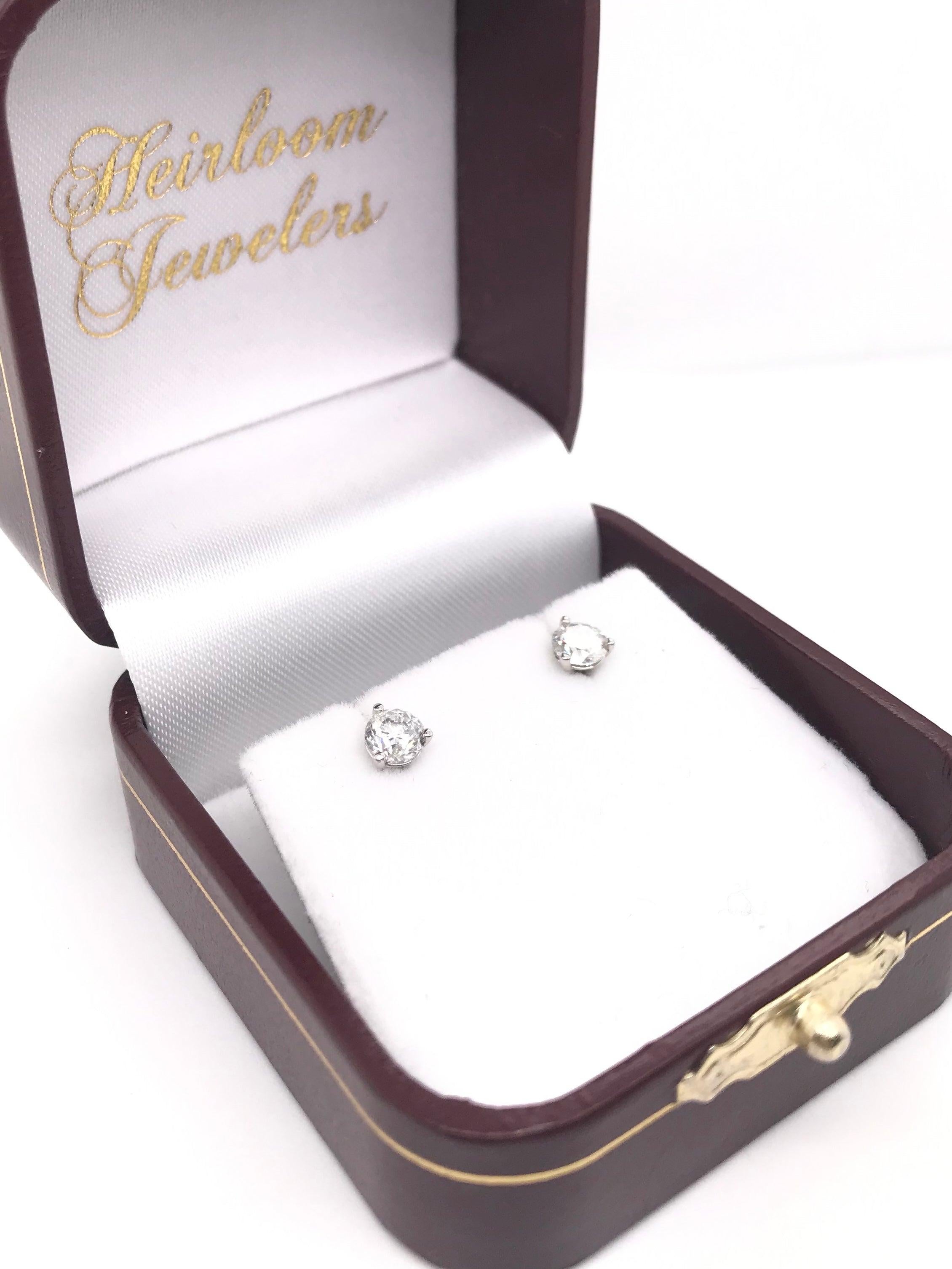 These contemporary style diamond earrings feature approximately 0.75 carats of diamonds; combined total weight. The settings are 14k white gold and are 
