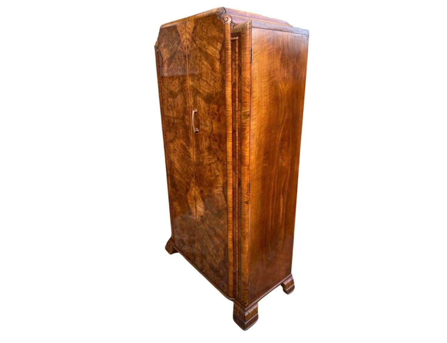 We are pleased to offer this attractive and extremely useful 3/4 size single Art Deco Wardrobe dating from circa 1930. The doors are a gorgeous conker colour with fabulous figured walnut veneers. They open to reveal a most useful fitted interior, to