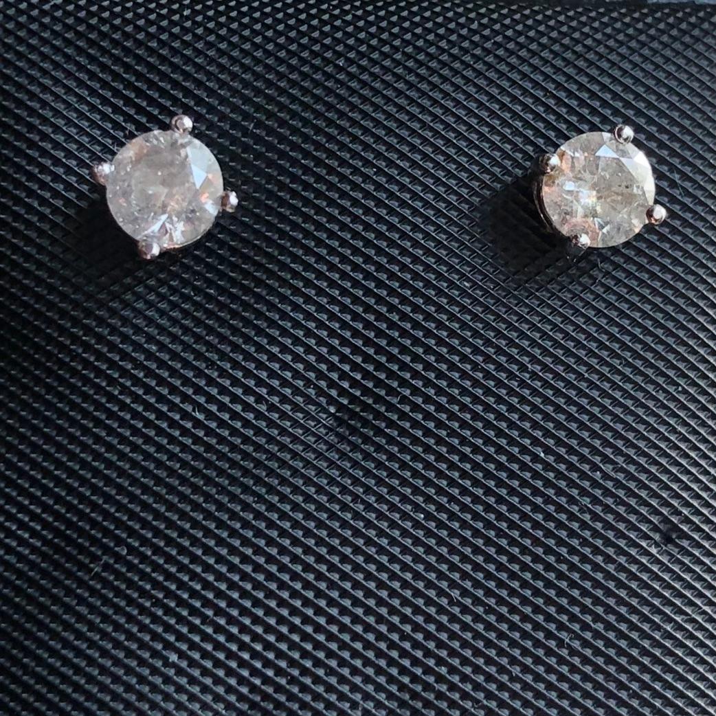 Classic 0.60 Ct solitaire diamond stud earrings in 14k white gold. Pair of natural earth-mined enhanced round brilliant diamonds weighing approx. 0.60 carat are prong set in these 14K gold basket studs.

Diamond stud earrings come with solid 14k