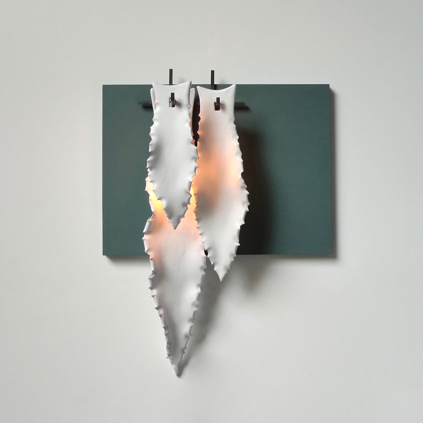 3 agave leafs wall light by Sander Bottinga
Dimensions: W 20 x D 13 x H 54 cm
Materials: Ceramic, forged iron, leather

Handmade matte white Agave leaves in ceramics from the famous ceramic village Grottaglie / Puglia in the south of