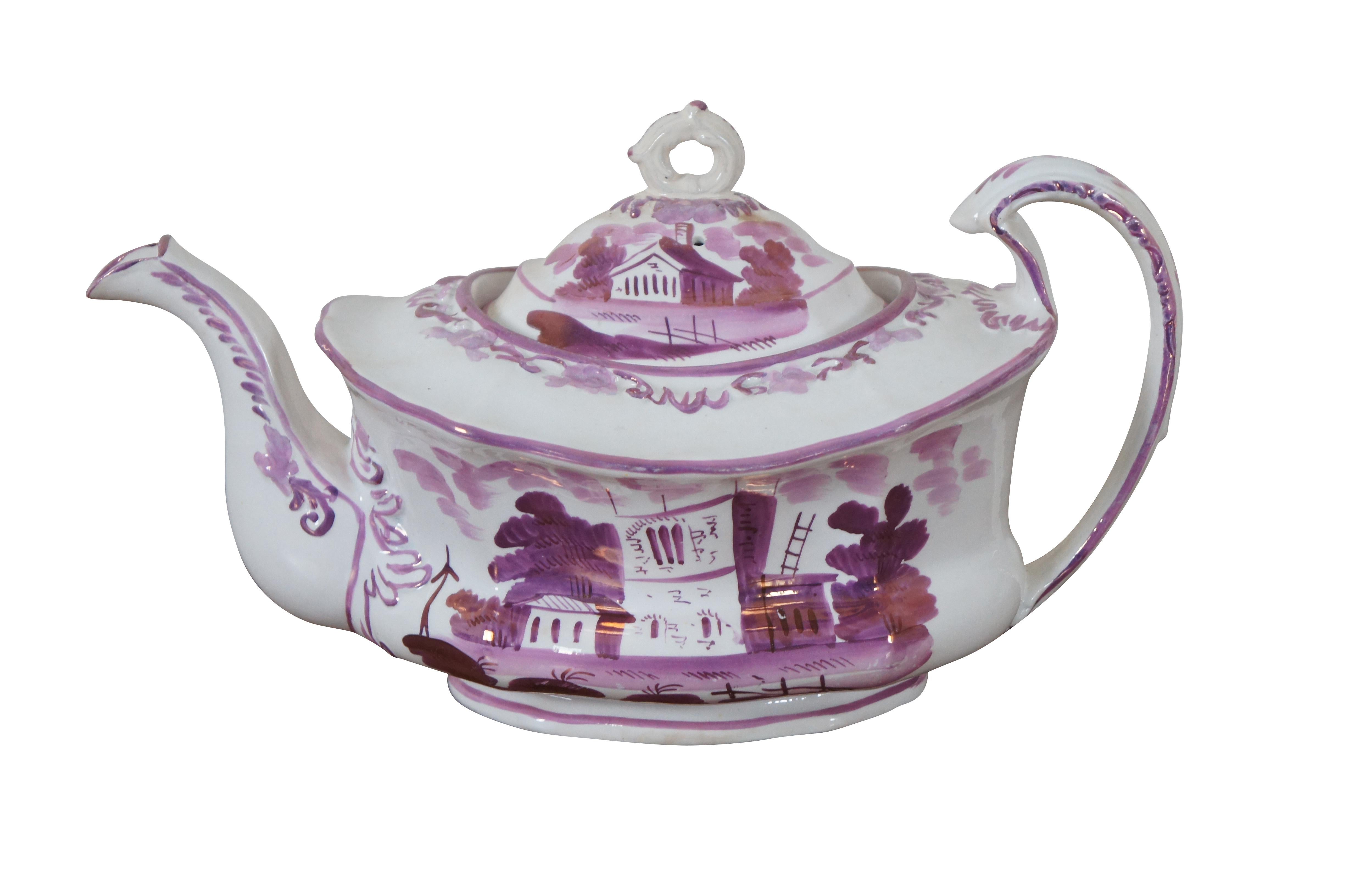 Antique 19th century lustreware tea set including teapot with lid, large sugar bowl with lid and cream pitcher, all beautifully hand decorated with landscapes and buildings in iridescent pink / purple.

Dimensions:
Tea Pot - 11.25” x 6” x 6.5” /
