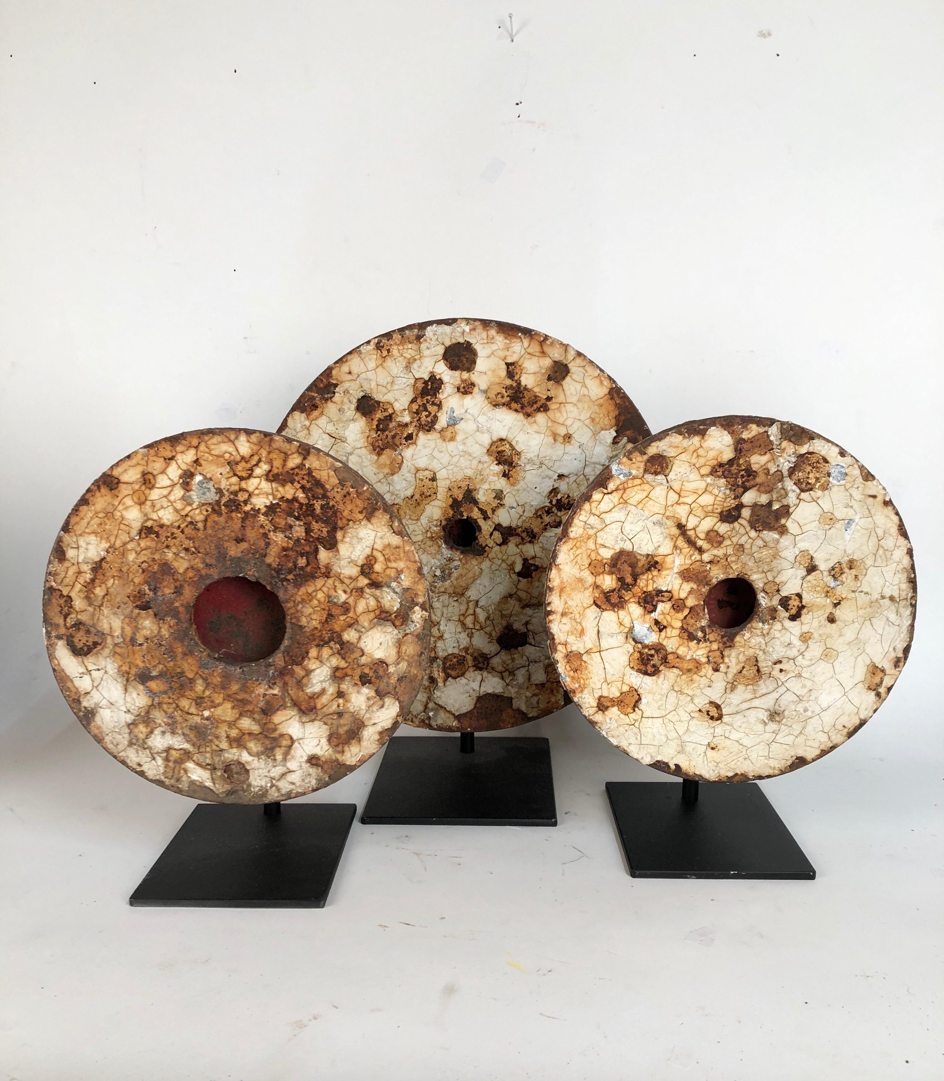 A group of three antique cast iron shooting gallery targets made by the same firm with extraordinary aged original white painted surfaces. All three have their original red strike plates. They range in depth from 6.25 to 7.5