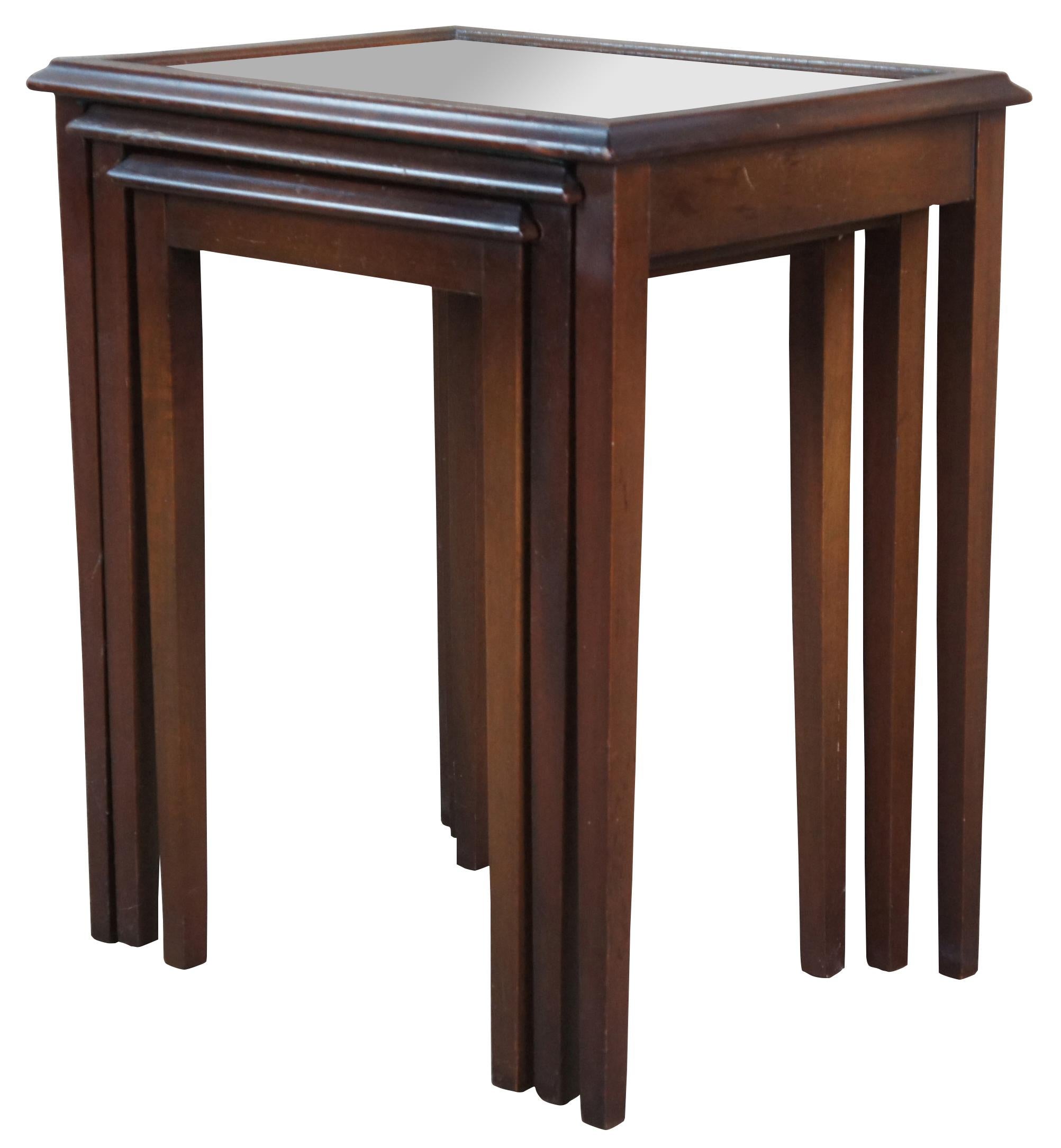 Nest of three antique Ferguson Bros Mfg Co side tables. Made of mahogany featuring a ogee edge, tapered legs, and glass tops. 5484.

Ferguson Brothers Manufacturing Company (founded 1878 in New York City) was was wholesale manufacturer of