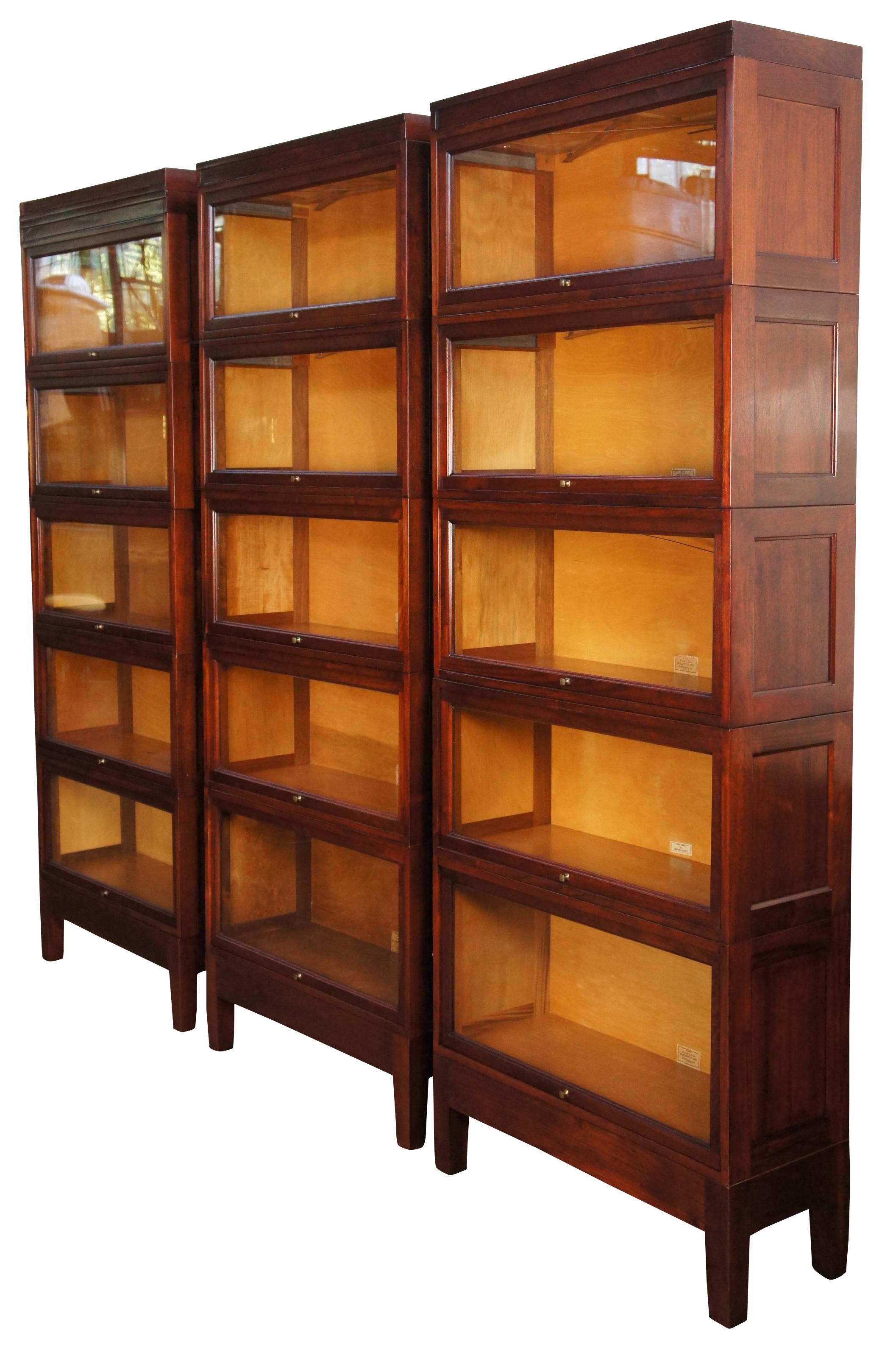 An amazing trio of Globe Wernicke Mission stacking library Bookcases, circa 1940s. Made of Genuine Walnut, Finish Number 374. Unit number 3313-B. GG. D. 14 & 16 Horizontal Units. Each set features a stack of 5 with original glass, brass hardware,