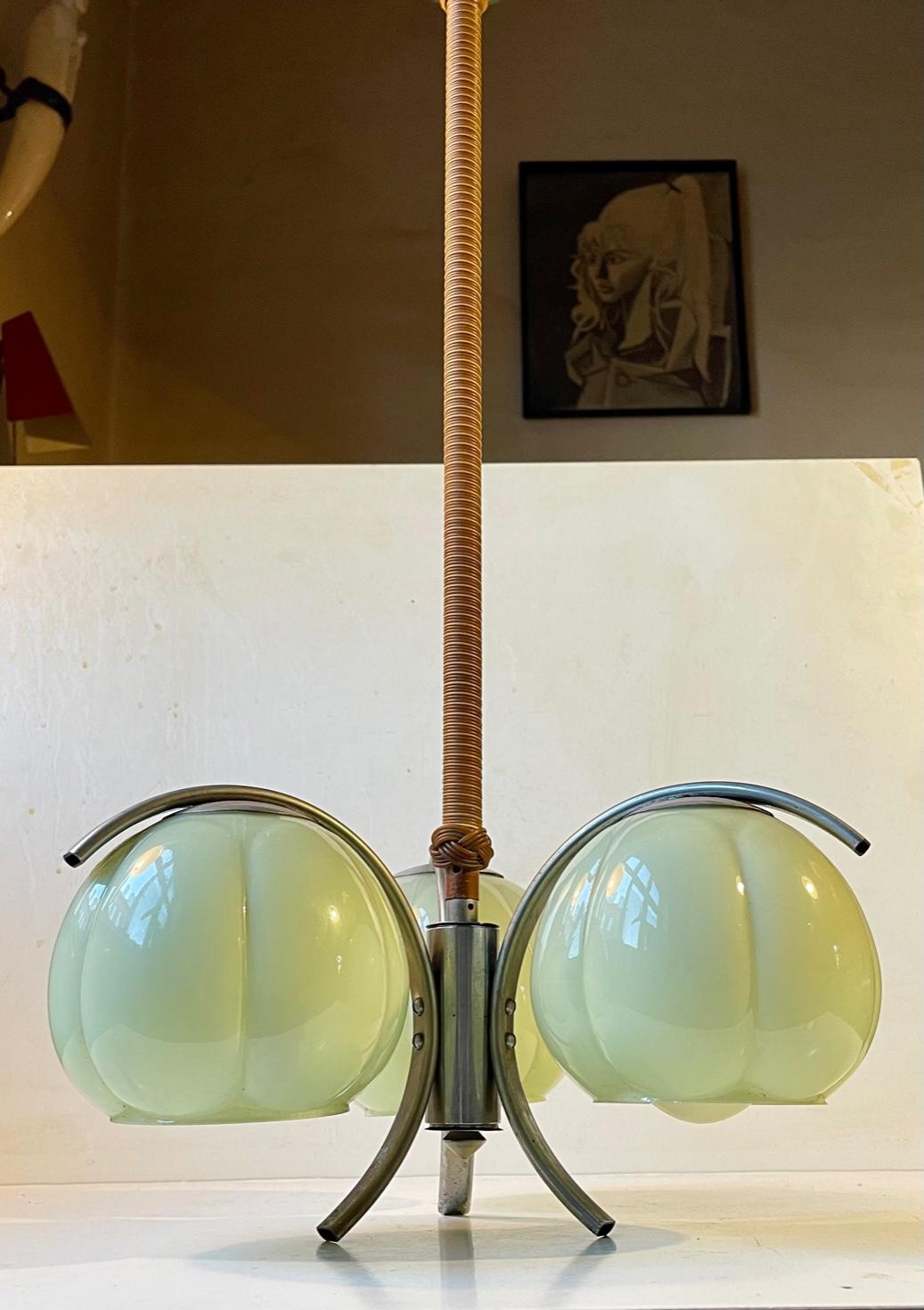 A stylish 3-shaded chandelier featuring 3 light green gourd shades, a nickel plated frame, hand-weaved/rolled rod with two-colored resin rattan and its original nickel canopy. It was made in Germany between 1930-40. Distinct functionalist styling