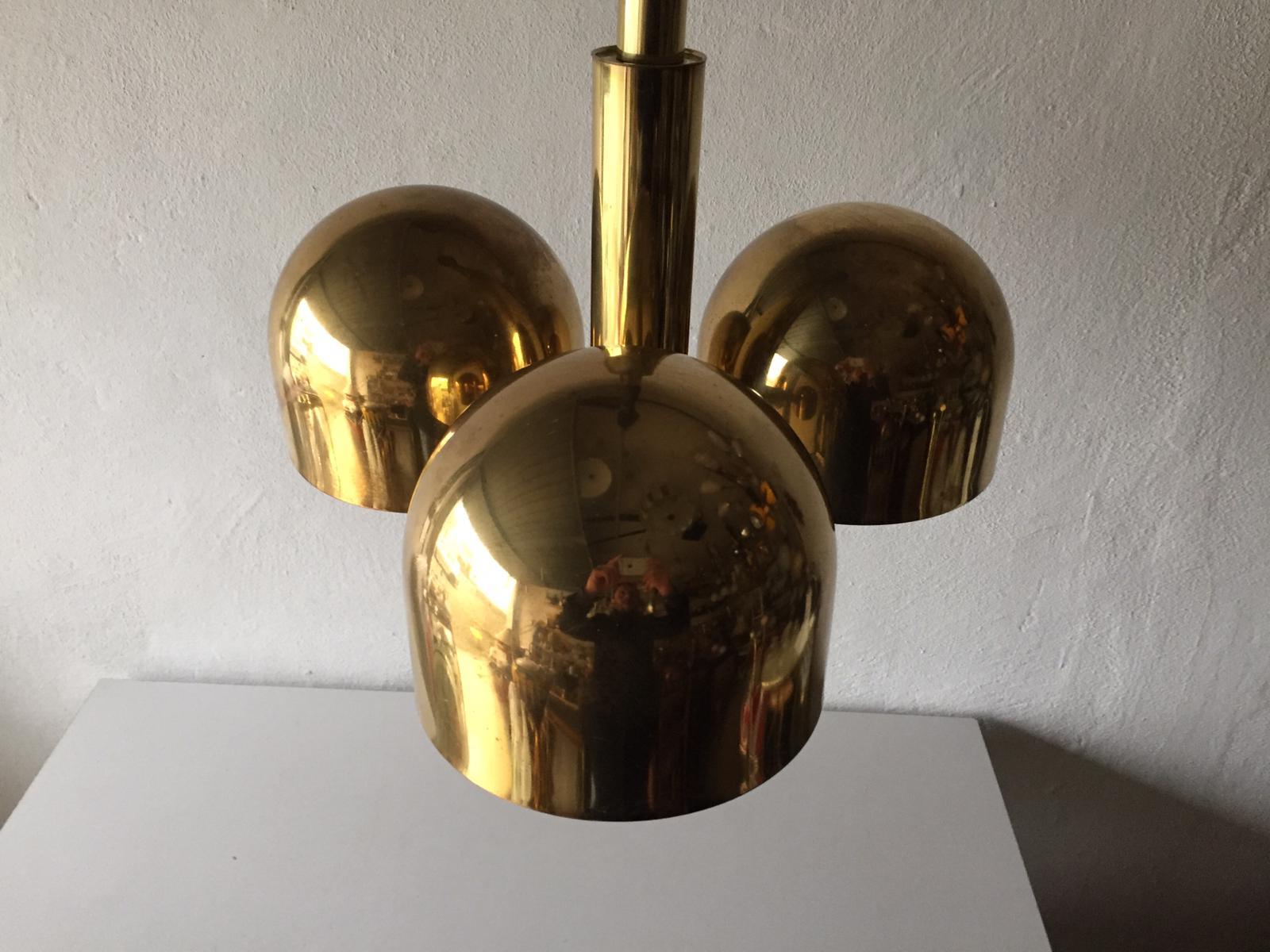 3 armed full brass body chandelier with adjustable hanging rope by Hillebrand, 1970s Germany

Unusual and rare design. 

Lampshade is in good condition and clean. 

This lamp works with 3 x E27 light bulbs. Max 100W
Wired and suitable to use