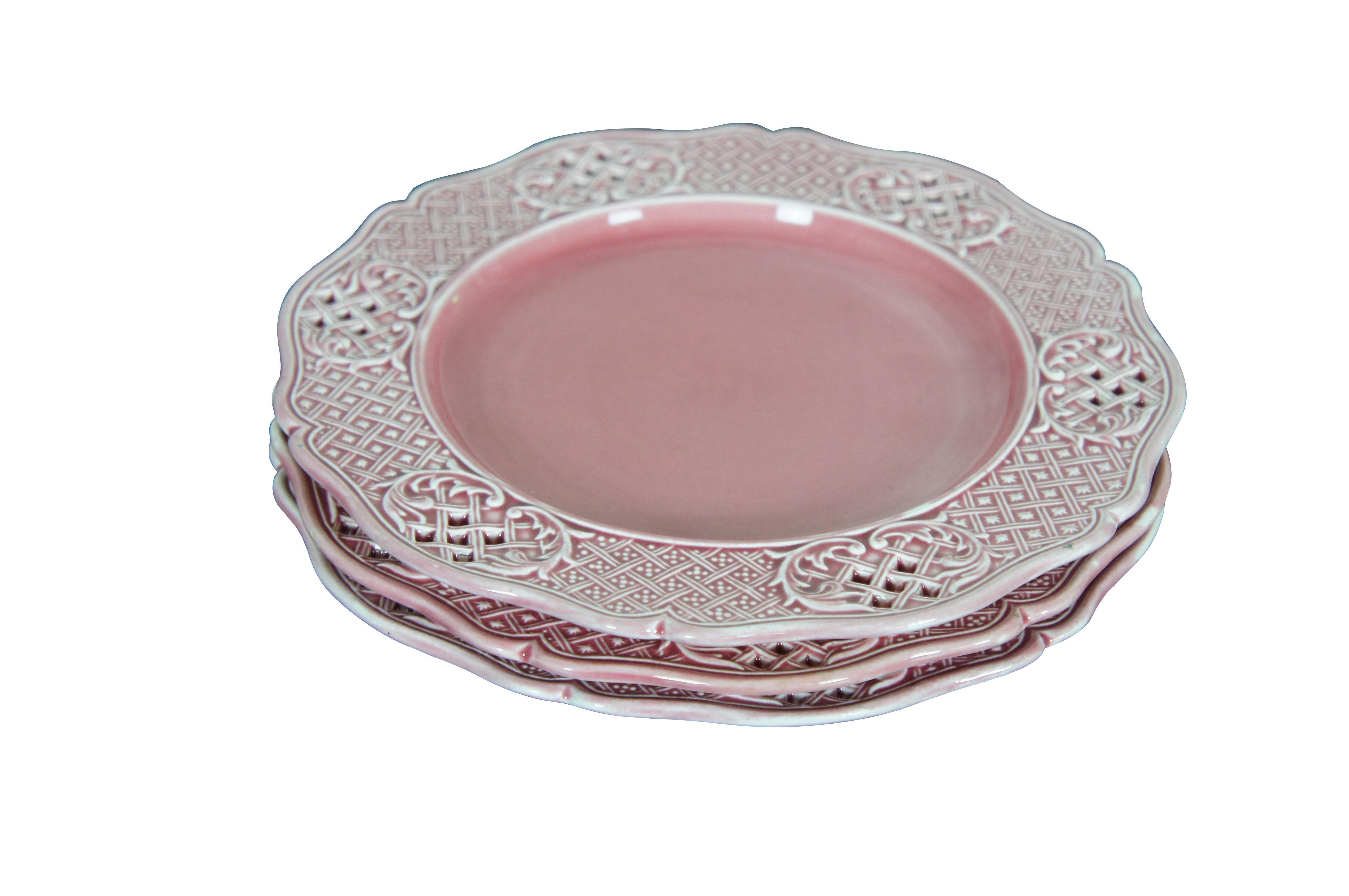 Three antique Austrian / Hungarian pink stoneware plates featuring a scalloped pierced basketweave lattice design.  Marked with Vienna beehive and K Y H. 

Dimensions:
8.5