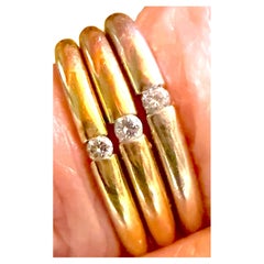 3 bands of 3 color 18K gold, each with a diamond