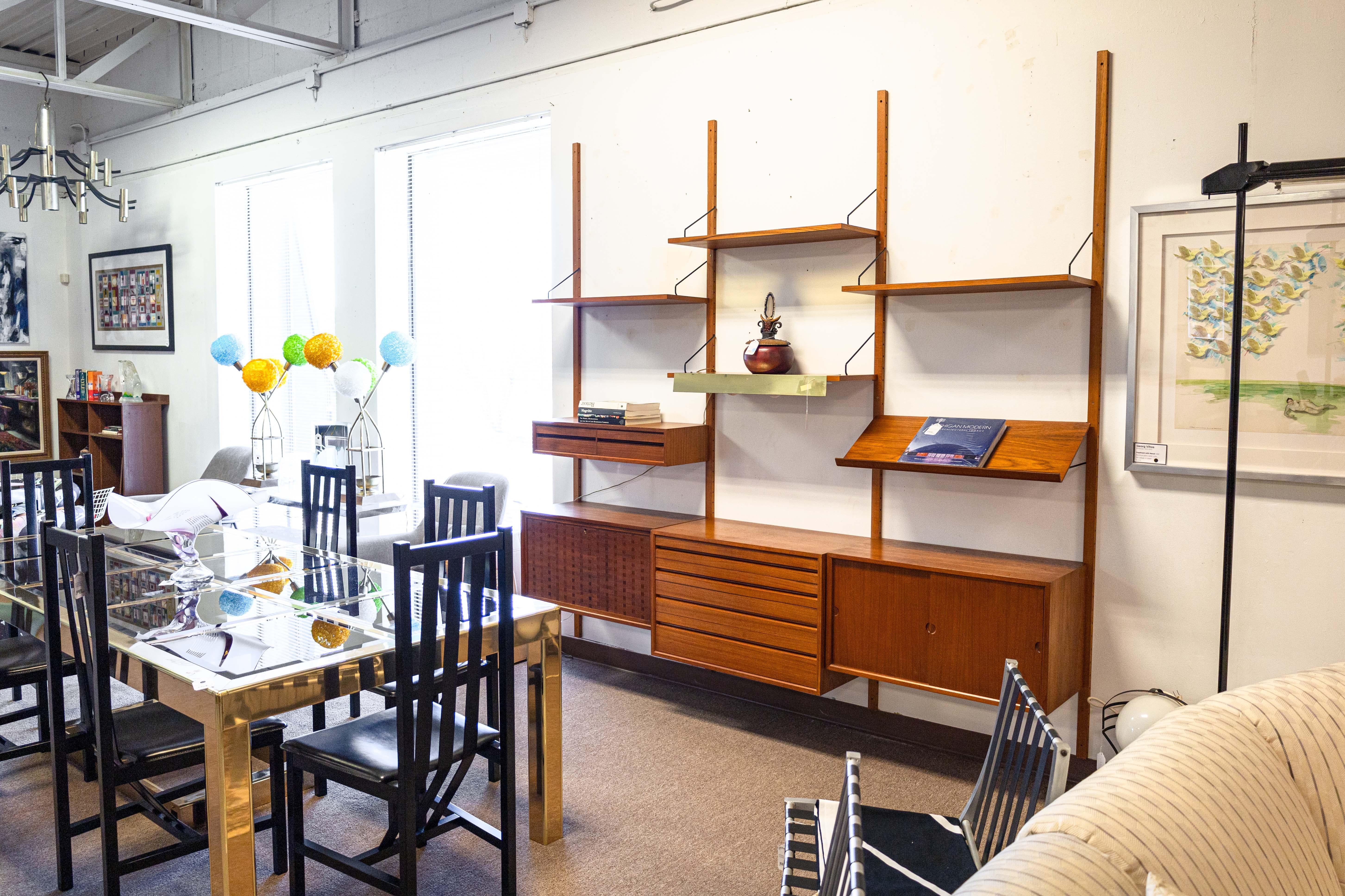 A Royal System Cado wall unit by Poul Cadovius. Poul Cadovius' Royal System was first introduced in 1945. Poul made the unit to create a space saving shelving system that rid them of wooden and metal legs, opting for a wall mounting system instead.