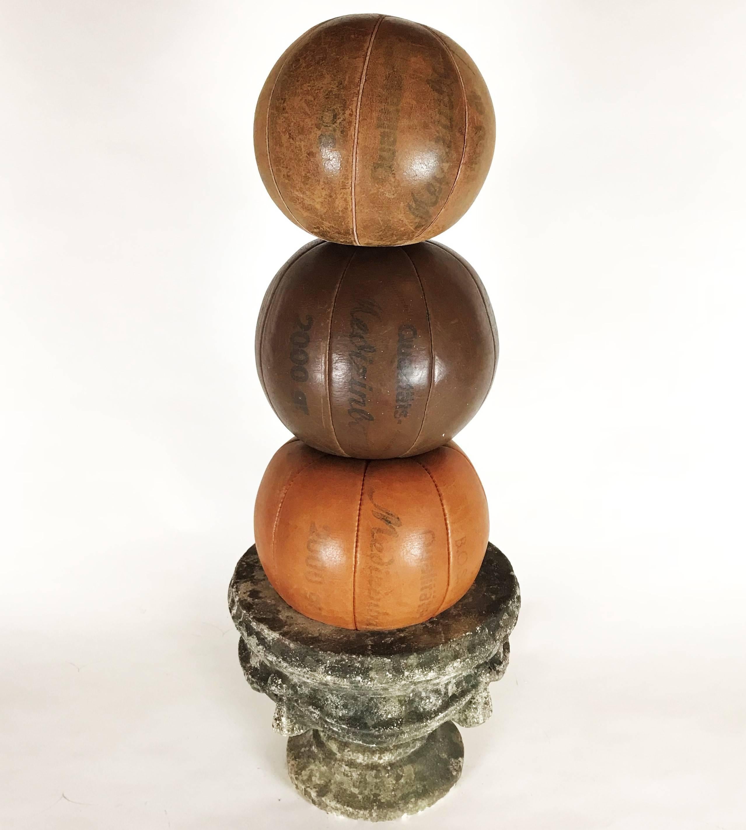 Three B.O.S leather balls. The medicine balls are part of a big collection from the 1920s-1930s, the time of the first gym enthusiasts in Europe. The balls are handmade, in a very good condition with nice patina and an intense color. 

Diameter: 23,