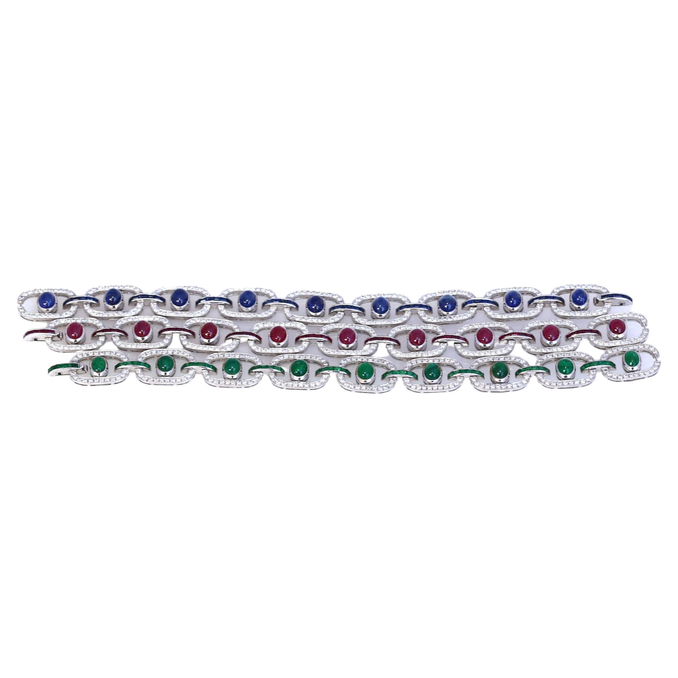 Three bracelets of identical design, decorated with cabochon and calibré-cut Emeralds, Sapphires and Rubies respectively. The fine idea behind the design is that each bracelet can be connected with the other to form a choker or a necklace. All three