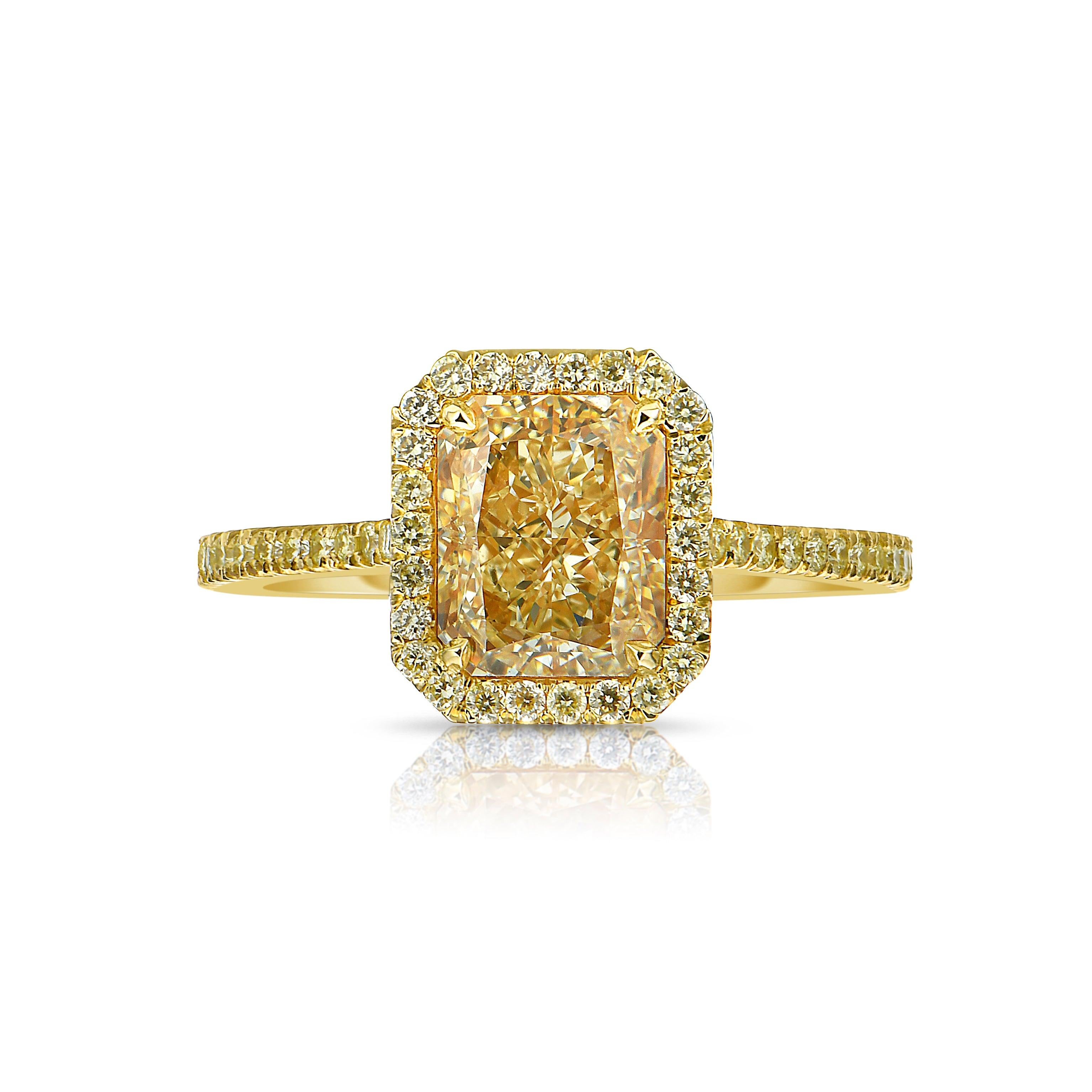 3.17 Carat diamond
Light Yellow (W-X)
0.37 Carats of Yellow Rounds 
VVS2 Clarity 
Elongated Radiant Cut Diamond
Excellent and Very Good Cutting
Set in 18k Yellow Gold 
Handmade in NYC
GIA certified diamond 

This piece can be viewed before purchase