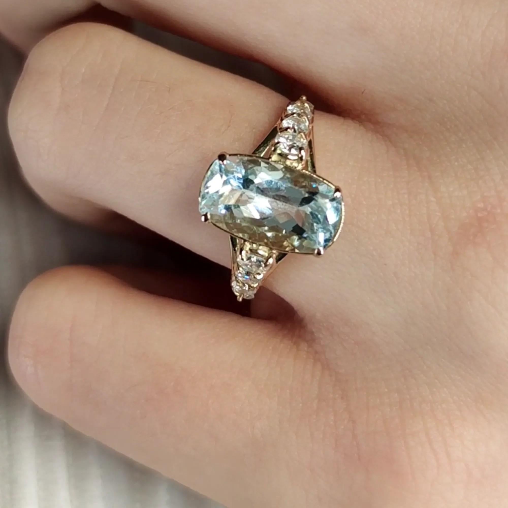 Elevate your style with our exquisite 3 Carat Aquamarine and 0.50 Carat Diamond 14K Yellow Gold Engagement Ring. Meticulously handcrafted, this unique women's ring features a central aquamarine enhanced by four tapered diamonds on each side. With a