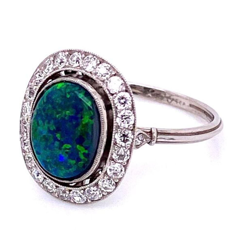 Simply Beautiful! Elegant and finely detailed Australian Black Opal and Diamond Art Deco Style Cocktail Ring center set with a securely nestled Australian Black Opal weighing approx. 3.00 surrounded by Diamonds, weighing approx. 0.60 total Carat
