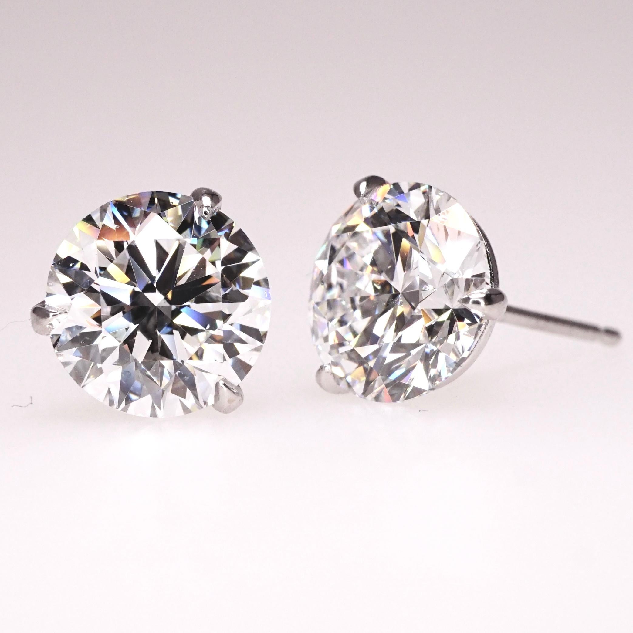 Brilliant Round diamond stud earrings set in Martini three prongs style setting In 18K white gold. Total carat weight: 3 ct. G color, SI1 clarity. Excellent cut. Excellent polish. Excellent symmetry. Fluorescence - none. Price may vary depending on