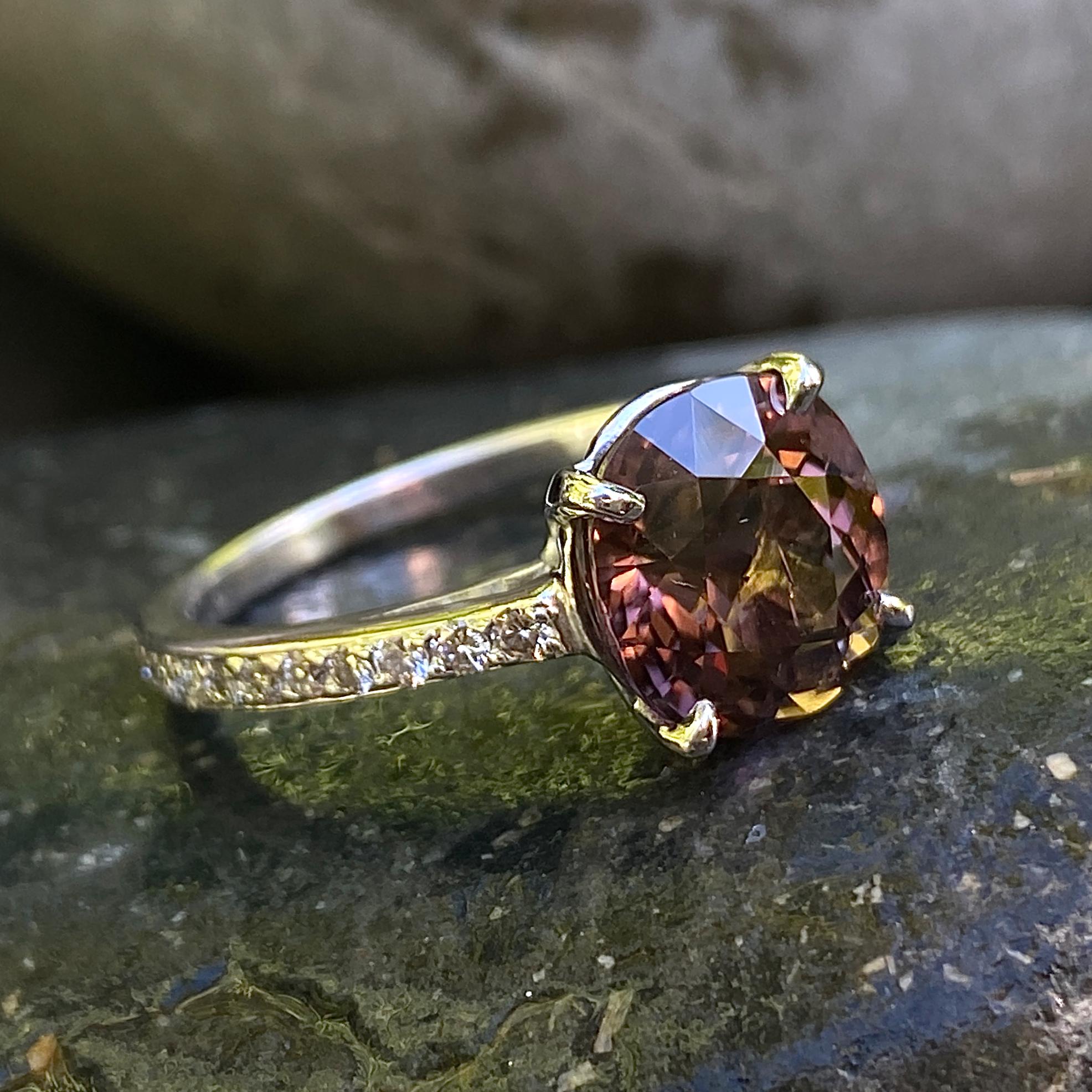We matched a 20+/- year old engagement ring setting with a large brownish-pink cushion cut tourmaline and got a spectacular result!  

The setting has graceful cathedral shoulders and a narrow full eternity band tightly set with very small diamonds.