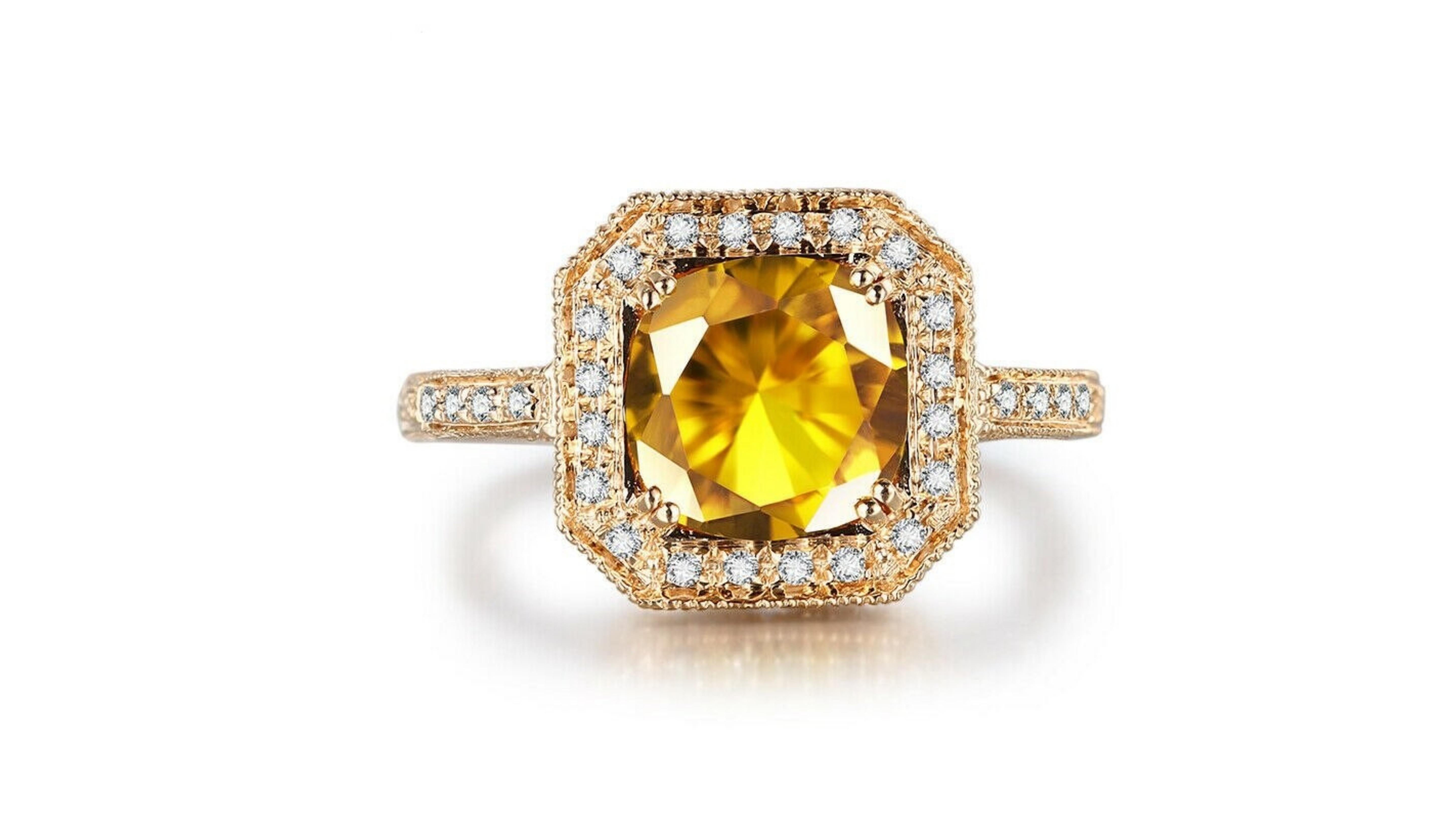 3 Carat Citrine Ring 14 Karat Yellow Gold with 28 White Diamonds in this very detailed design  as you can see in  the band. 

Citrine is the yellow variety of quartz, and its name comes from the Old French word for lemon. Its warm colour is said to