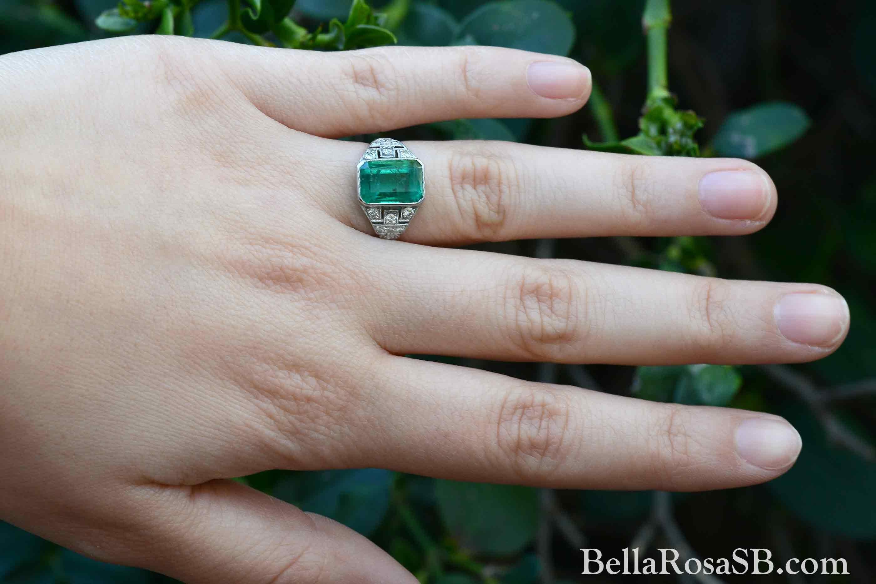 We are pleased to offer this certified Colombian emerald Art Deco Engagement ring. An enchanting green which has inspired generations of collectors to seek Colombian Emeralds for their verdant color. A fine, 3.20 carat gem is the heart of this