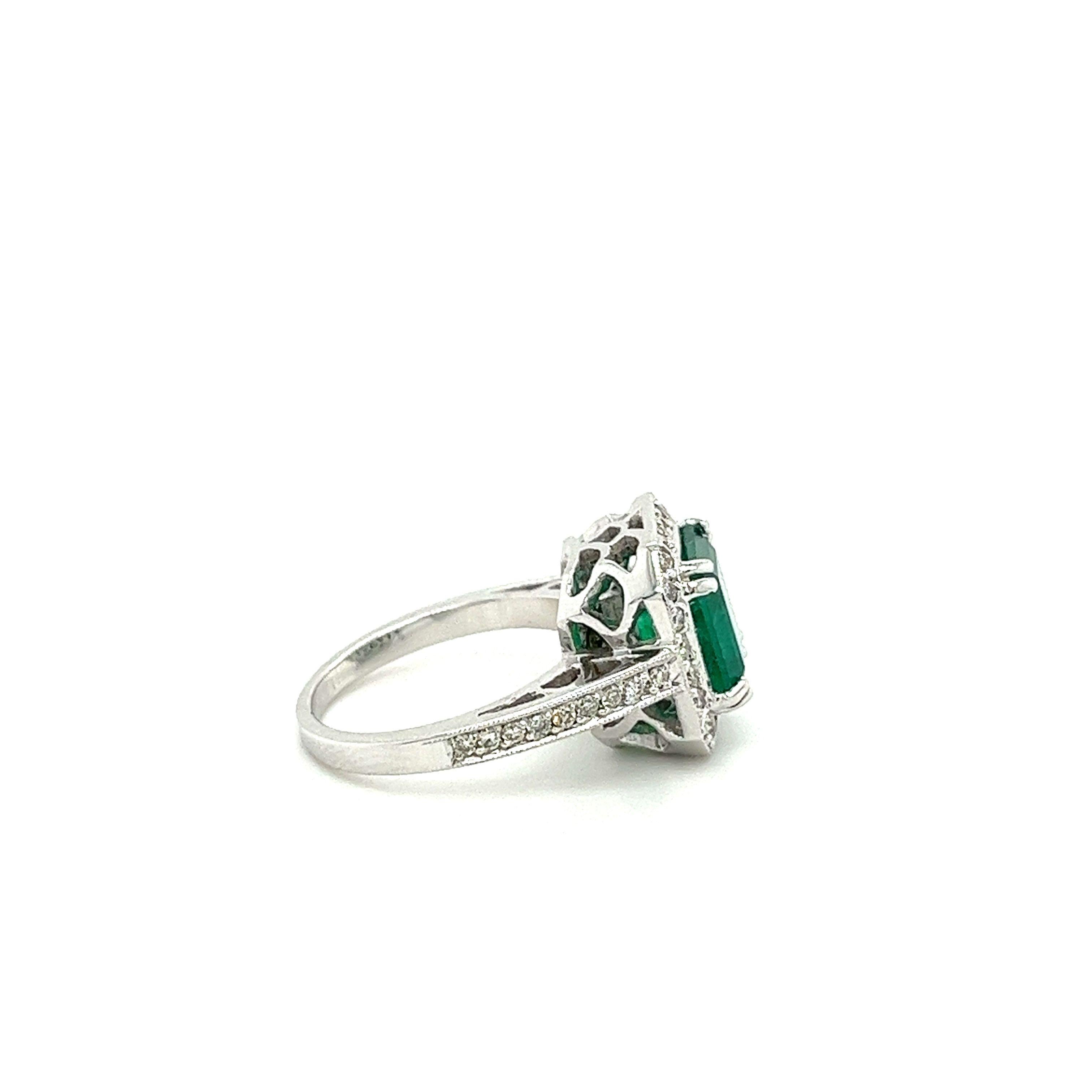 3-carat Colombian emerald ring, set in 18k white gold. This remarkable gemstone bears a rich, dark green color with exceptional luster, brilliance, and transparency. 42 round cut diamonds are perfectly placed around the emerald, forming a sparkling