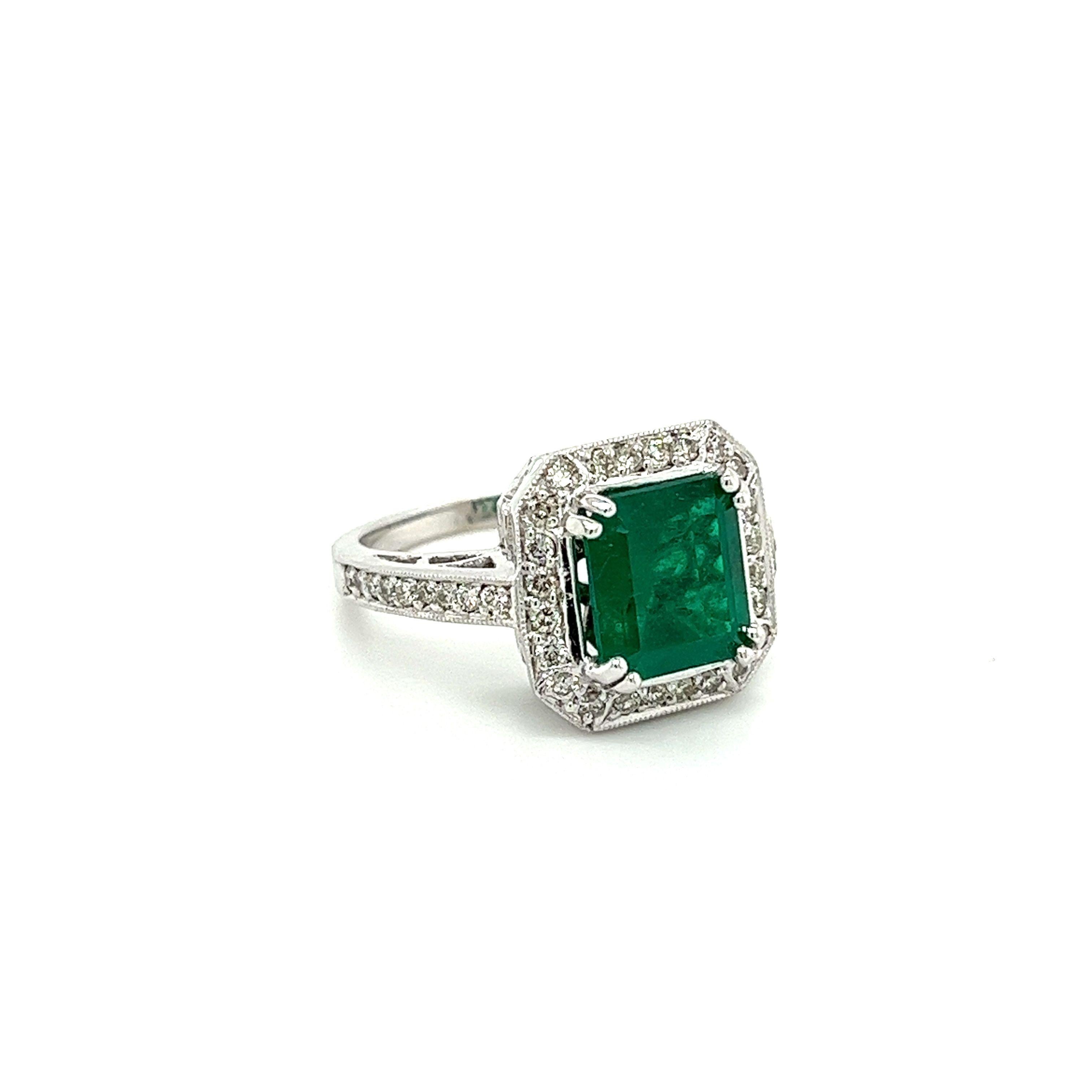 Emerald Cut 3 Carat Colombian Emerald in 18K White Gold Ring & Round Cut Diamond Halo For Sale
