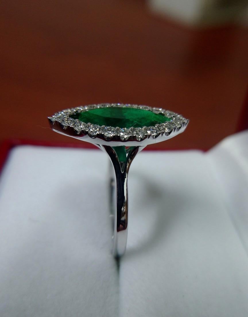 Contemporary 3 Carat Colombian Emerald with Diamond Halo Ring For Sale