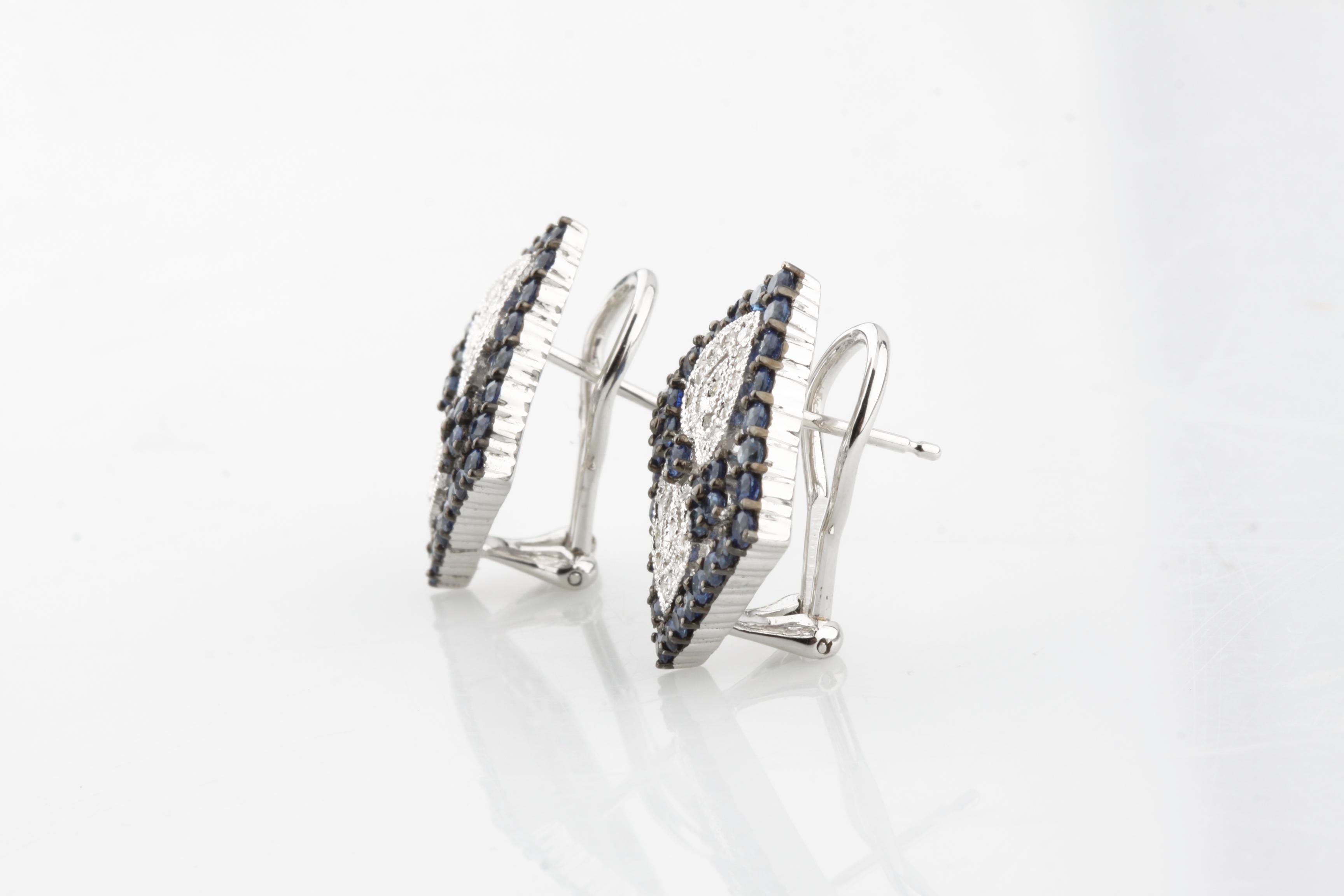 Beautiful Square Plaque Earrings
Feature Round Prong-Set Sapphires in Antiqued Plaque
Pave-Set Diamond Heart Accents with Milgrain Detailing
Total Carat Weight of All Stones = 3 cts
Total Diamond Weight = Appx .40 Cts
Total Sapphire Weight = Appx