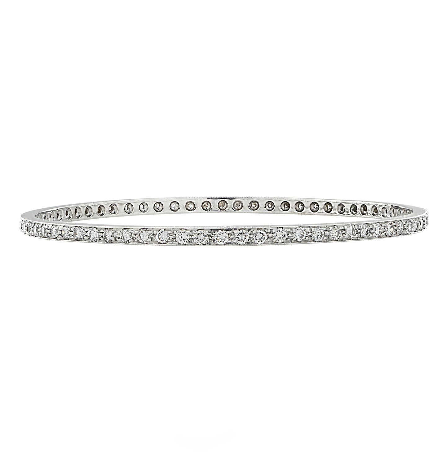 Stunning bangle bracelet crafted in 18 karat white gold, featuring 68 round brilliant cut diamonds weighing approximately 3 carats total, G color, VS clarity. This gorgeous diamond encrusted bangle measures 2.3 inches in diameter and .1 of an inch