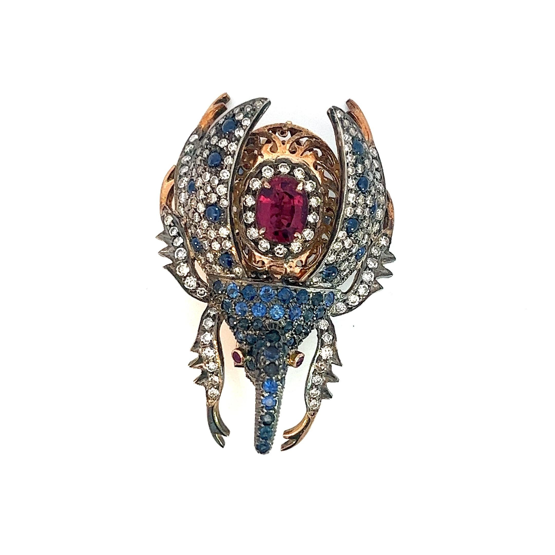 Introducing our extraordinary 3 Carat Diamond, 2 Carats Sapphire, and 3.5 Carat Spinel Beetle Pin, a truly remarkable piece of jewelry that showcases the captivating beauty of diamonds, sapphires, and spinels, all set in opulent 18K gold. This