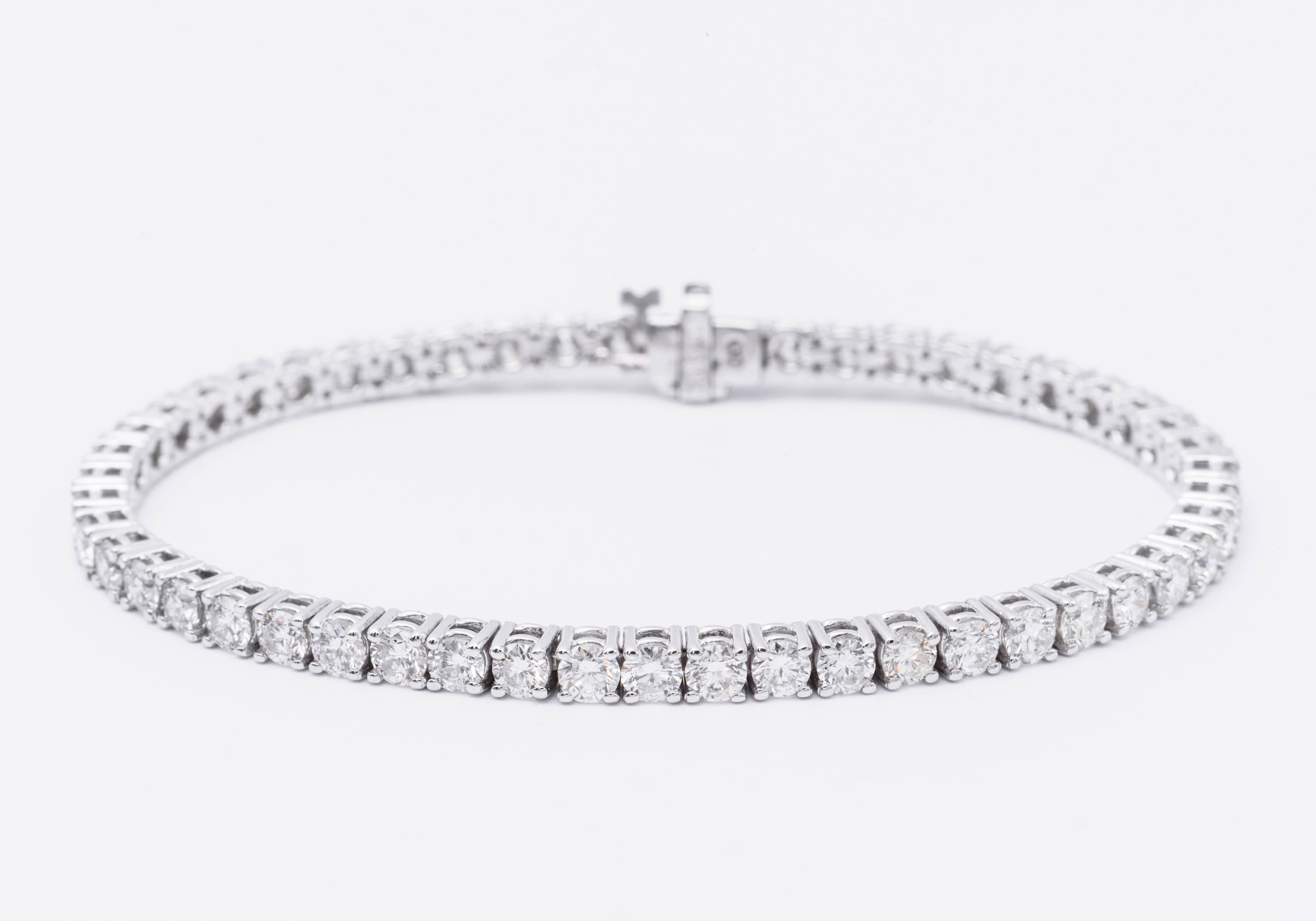 14 Karat White Gold diamond tennis bracelet featuring 61 round brilliants weighing 3 Carats.
Color G-H
Clarity SI

Can be made in 18 Karat White Gold or Yellow Gold
DM for pricing.

In stock 1-22 Carat Tennis bracelets.