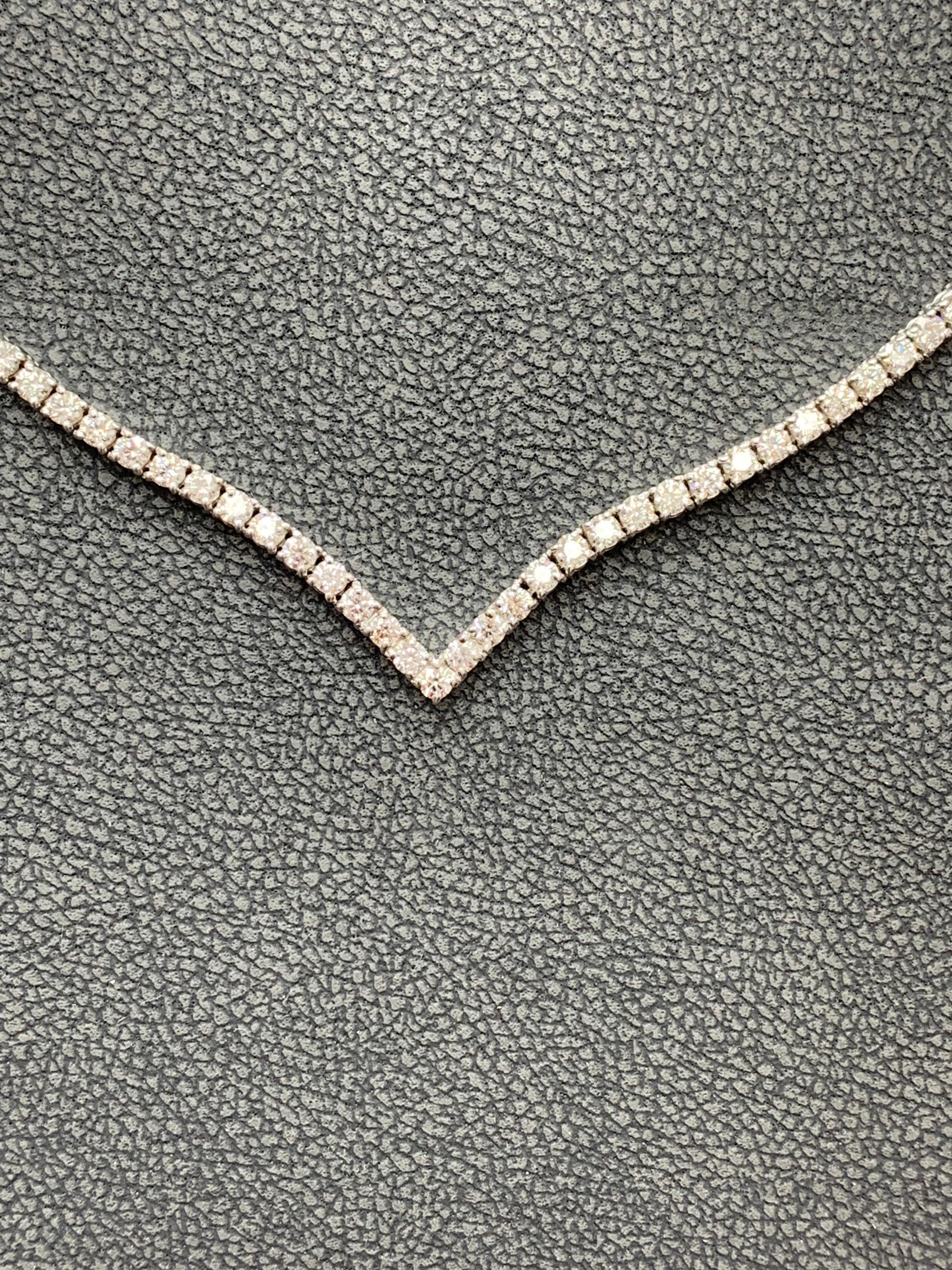 A brilliant and classic tennis necklace showcasing halfway of diamonds and halfway of gold towards the back. The 89 diamonds in this necklace are brilliant round cut and 
weigh 3 carats in total made in 14K White Gold. 16 inches in length.