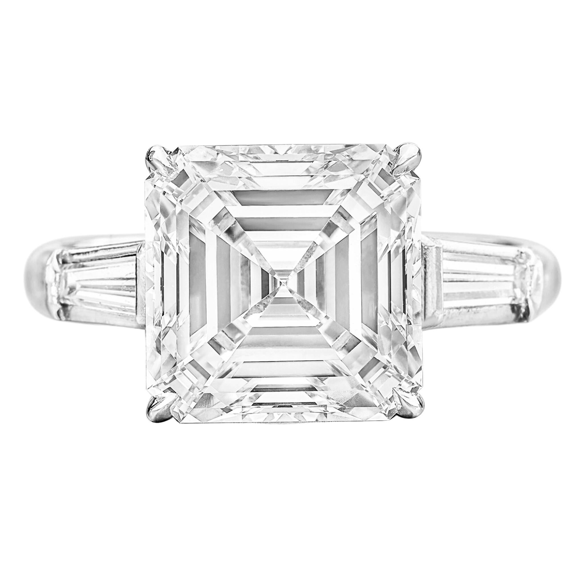 This exquisite ring features a stunning 3-carat emerald square-cut diamond, certified by the Gemological Institute of America (GIA). The GIA certification ensures the diamond's exceptional E color grade, indicating a rare and highly desirable level