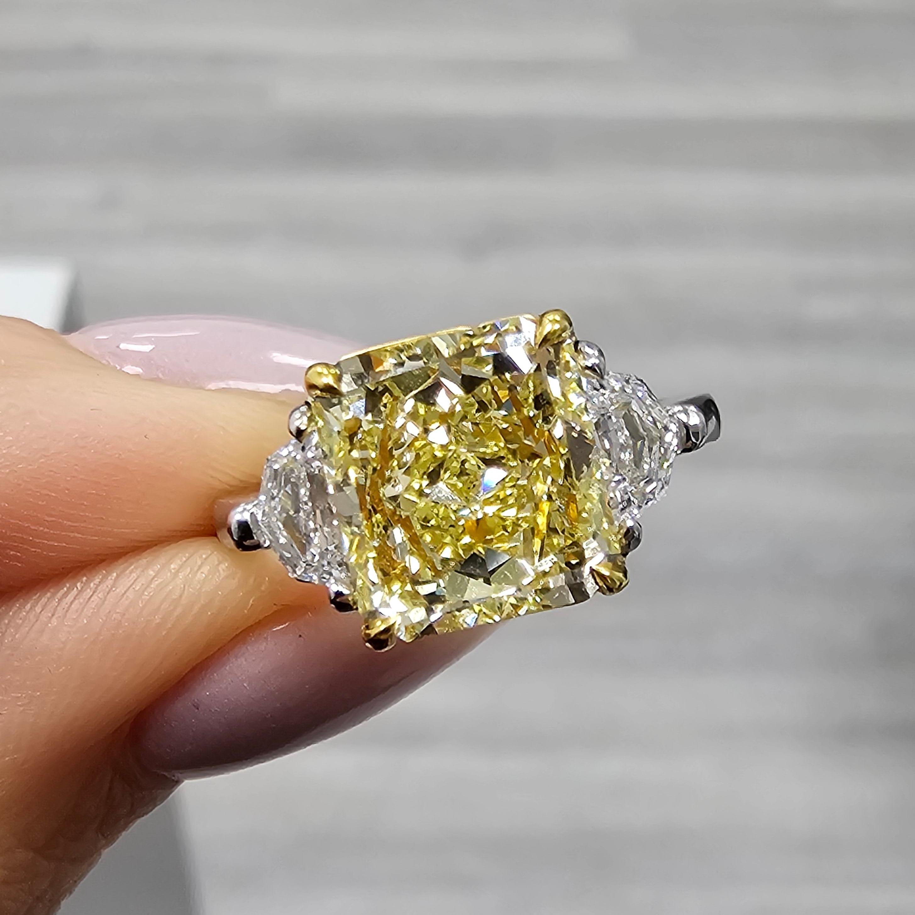 3ct Fancy Intense Yellow 
Square Radiant Cut
Eye clean
Set in Platinum and 18kt Yellow Gold with 0.41ct Epaulettes 
Great for everyday wear and for dressy events
This piece can be viewed before purchase in our showroom in NYC or at one of our retail