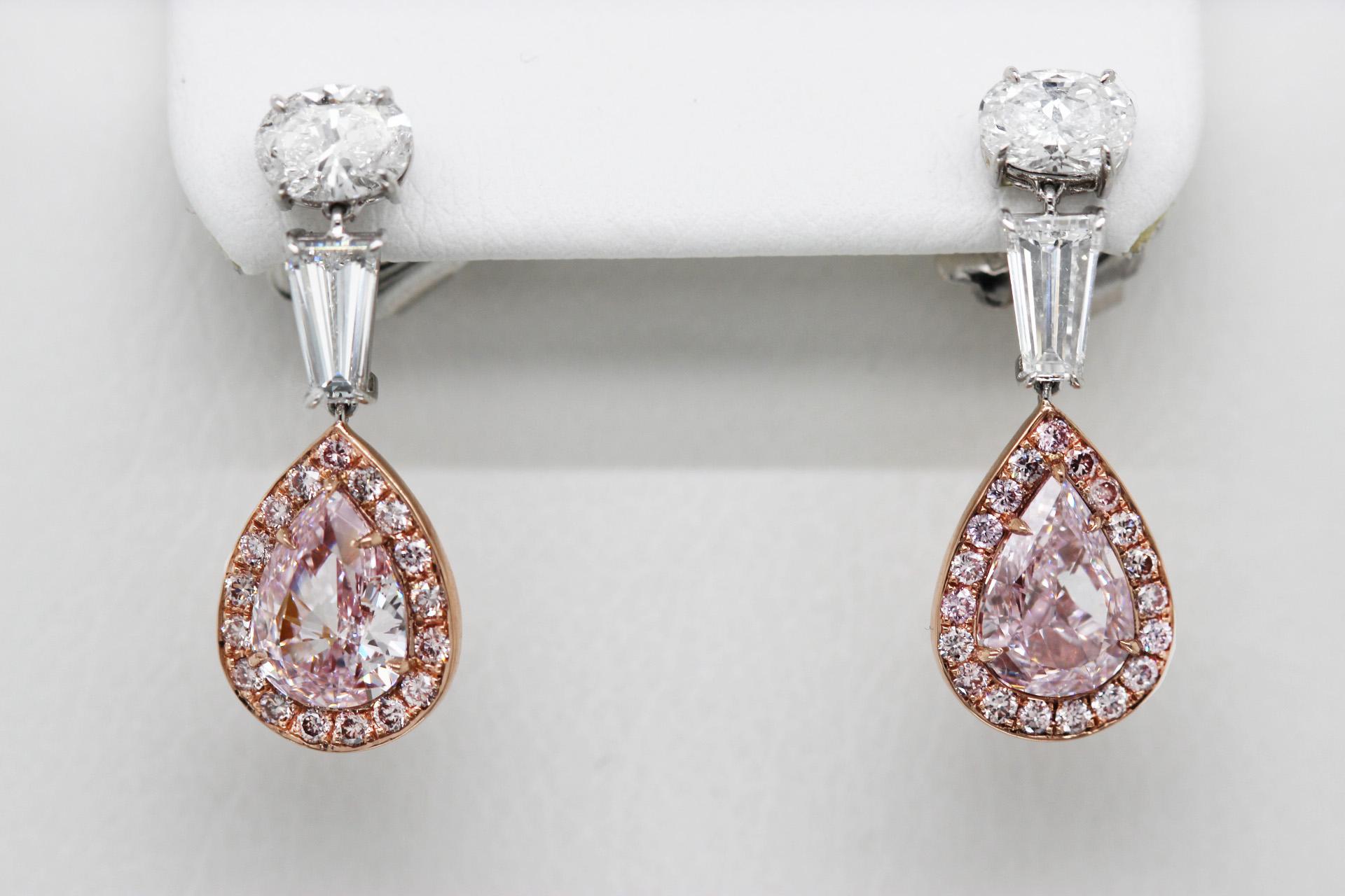A pair of natural pink diamond dangle earrings from Scarselli, with a total carat weight of 5.48. Set on 18k rose gold and platinum, the pair features two exceptional GIA-certified fancy pink diamond center stones.

The upper portion of the earrings
