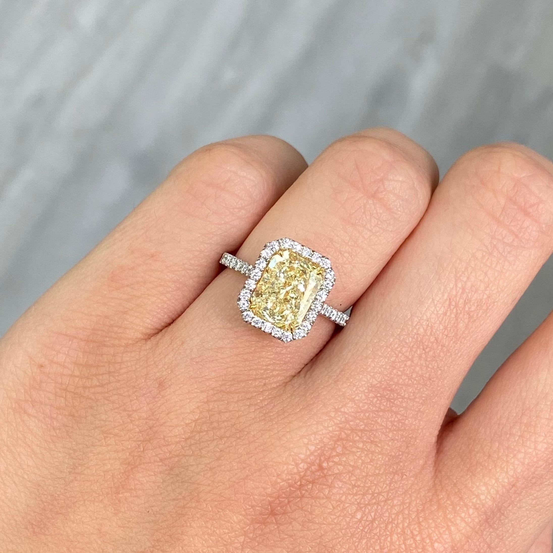 3.31 Carat 
Light Yellow (W-X)
VS2 Clarity 
Radiant Cut Diamond 
0.44 Carats of White Rounds 
GIA Certified Diamond 
Crafted in Platinum and 18k Yellow Gold 
Handmade in NYC

This piece can be viewed before purchase in our showroom in NYC, or at one