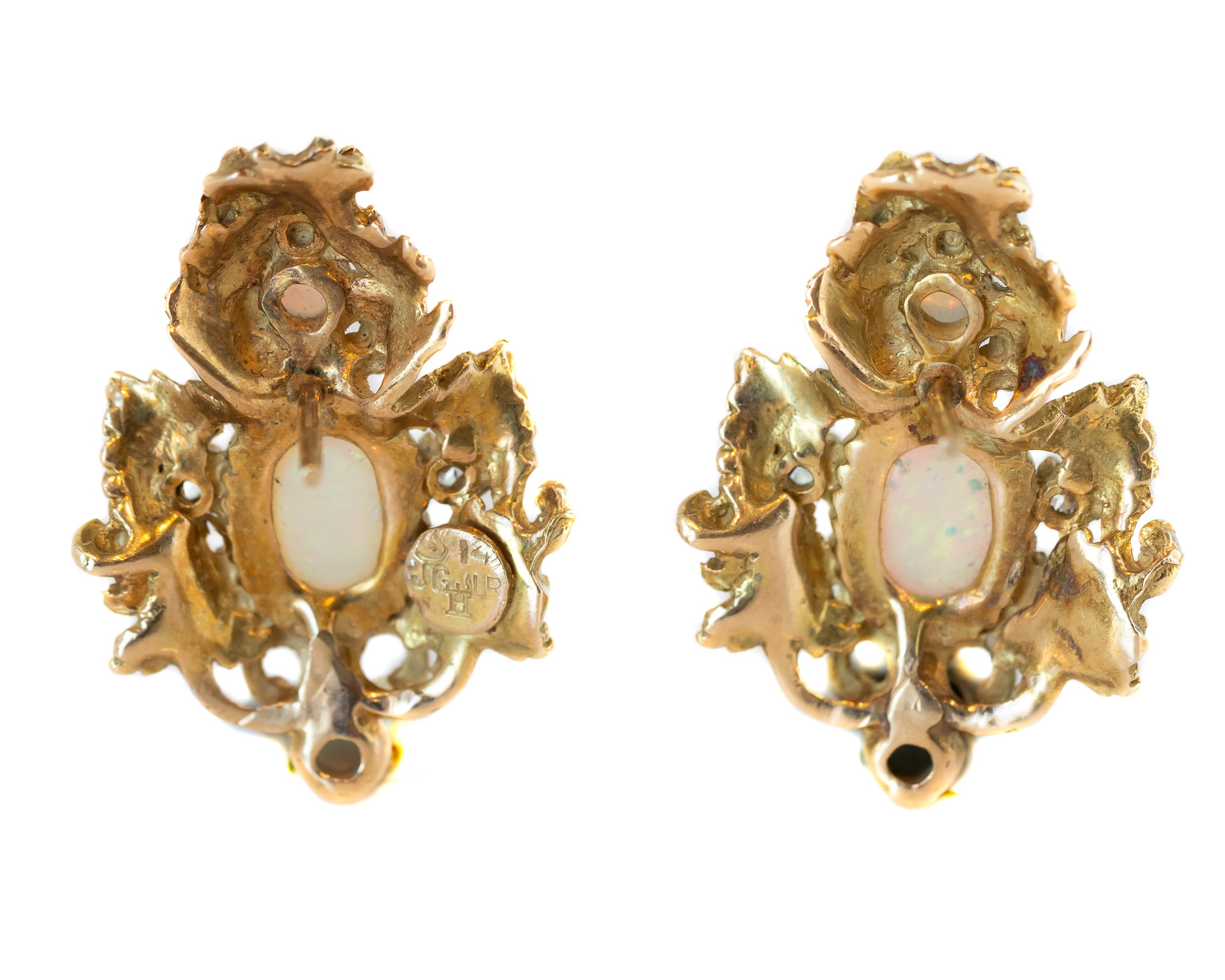 Baroque-Inspired Gold, Opal and Diamond Earrings crafted in 14 karat Yellow Gold, Opals and Diamonds

Baroque-Inspired Feather/Floral Design Gold studs with 2 Oval Opals, 4 Round Opals and 8 Round Brilliant Diamonds
Opals have fiery Pink, Blue and